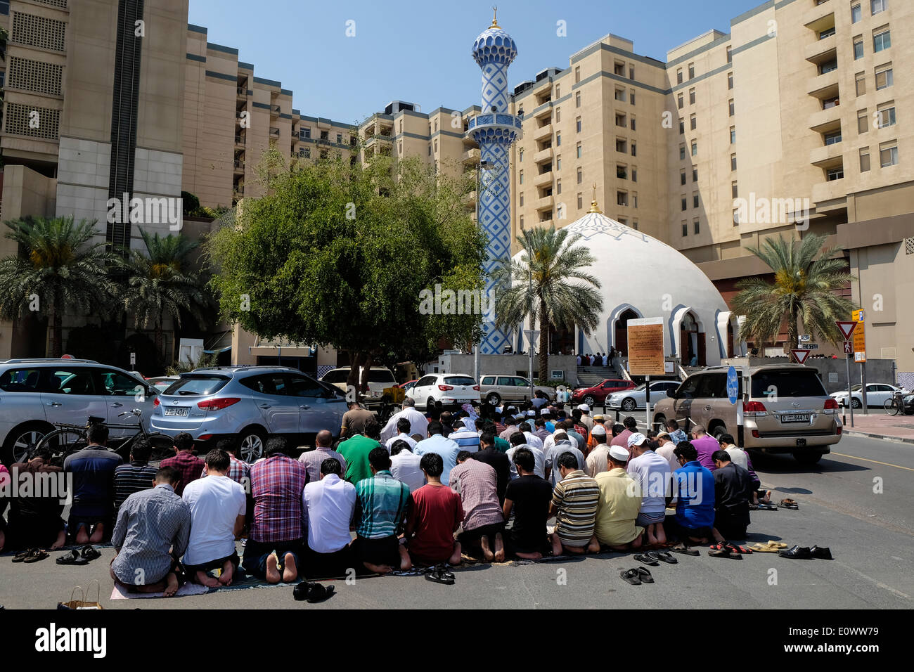 Many men praying on Friday outside mosque at Burjuman shopping centre in Dubai United Arab Emirates Stock Photo