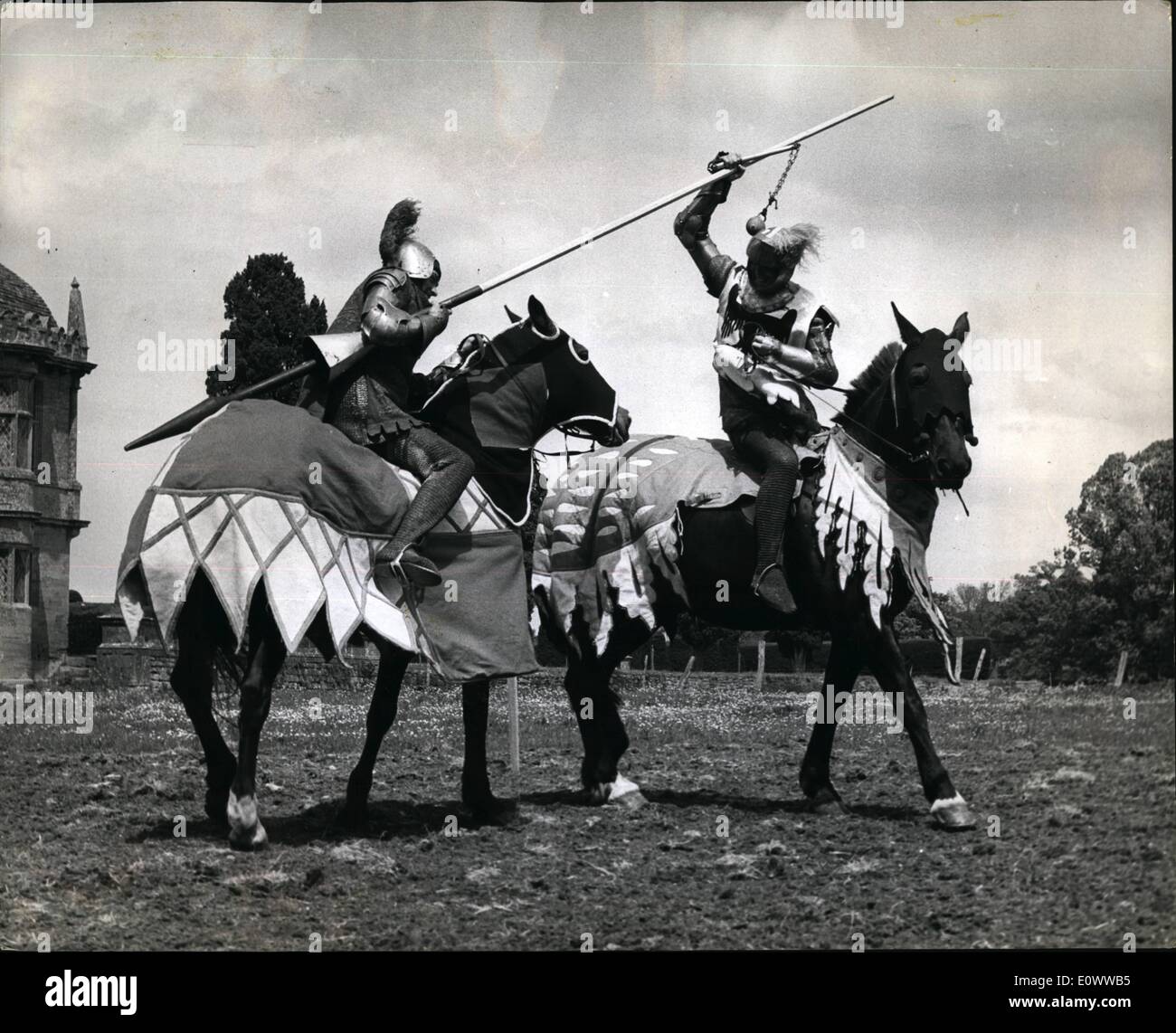 May 05, 1964 - Jousting - Down In Somerset.. Lances And ''Coshes''.... Jousting between knights armed with lances and swords will be seen in Britain again soon after 125 years. Seven top point-to-point horsemen will ''do battle'' at the Eilzabethan Montacute House, Yeovil, Somerset. It is all part of the &pound;2,500 one-day sports tournament to be run by the National Trust. compete in armour - ''Knights'' were to be seen in training. Keystone Photo Shows:- Lieut. Ralph Cowdy (Left) with lance battles on horseback with Lieut. Micheal Goodbody who swings a ''Cosh'' (19th Stock Photo