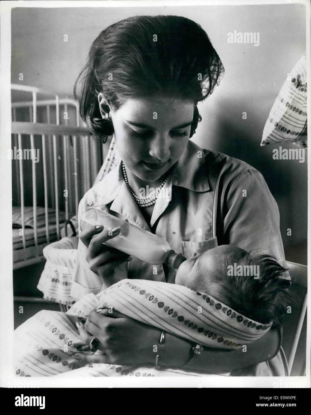 Jun. 06, 1964 - Greek Queen-to-be learns child nursery.; Princess Anne-Marie, who is engaged to King Constantine of Greece has some time been learning child nursery at at Copenhagen home for children. Her wedding to the King is due to take place in Athens on September 18th. Photo shows the Princess bottle-feeds a baby. Stock Photo