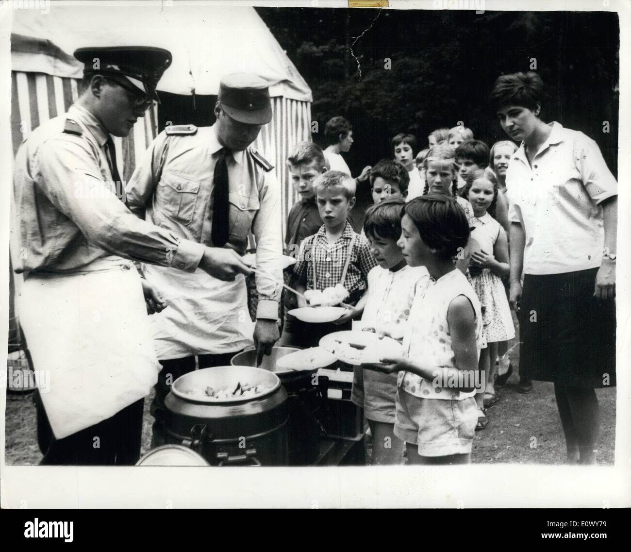 Jun. 06, 1964 - Soldiers Cook For Volkhoven Children. Survivors Of The Terrible Flame-Thrower Attack: The School children of Volkhoven, near Cologne - Germany - who survived the recent flame thrower attack - which resulted in the death of seven children and two teachers - are now recovering from their shock at a Municipal report near their home-town. Soldiers of the Bundeswehr have volunteered to cook for - and to take care of the children - so they can soon forget their terrible experience Stock Photo