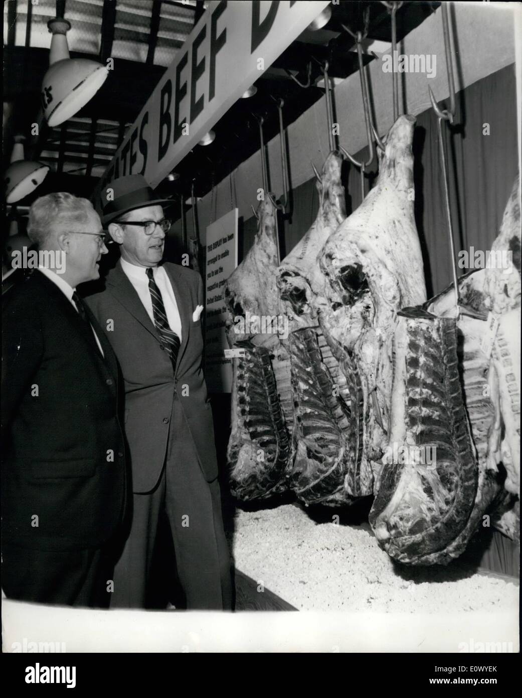 Jun. 16, 1964 - 16-6-64 American beef on show at Smithfield. A cargo of 46 quarters of United States chilled beef weighing 7,000 lbs. has been shipped from America to be exhibited by the U.S. Department of Agriculture and the American Meat Institute at London's Smithfield meat market in an effort to develop new markets for American products. Photo Shows: Mr. W.M. Justice (left) a director of British grocery chain Sainsburys, and buyer Mr. Bob Wallis seen examining some of the American beef on show at Smithfield this morning. Stock Photo