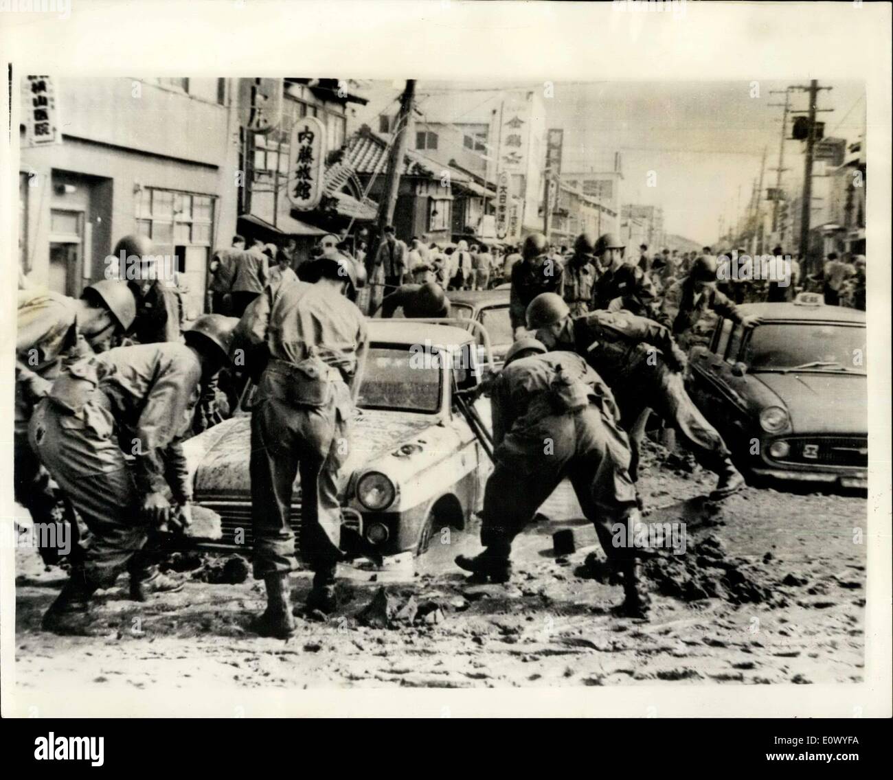 Jun. 22, 1964 - Japanese earthquake disaster: The city of Nigata was reduced to a blazing shambles by the earthquake which struck last Tuesday, isolating it from the rest of Japan, as railway lines buckled and the runway of the airport partly disappeared. Now there is no water, electricity or sewerage, and thousands are homeless. The port of Nigata, one of the principal oil refining cities, suffered a double catastrophy as oil tanks burst spreading blazing oil over hundreds of houses nearby, destroying 291 of them. The 90 oil tanks which went up in flames contained 400,000 kilolitres Stock Photo