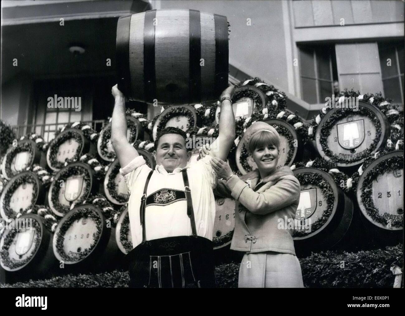 Oct. 06, 1964 - Many strength............so thought Heidi Bruhl, the star of the musical ''Annie get you gun'' after she has tested the muscles of Johann Schneider (JOHANN SCHNEIDER), world champion by stemming casks'' By word and deed the actress helped Johann Schneider and his colleagues when they brought back the beer casks from the closed Oktoberfest to the brewery on October 5th. Stock Photo