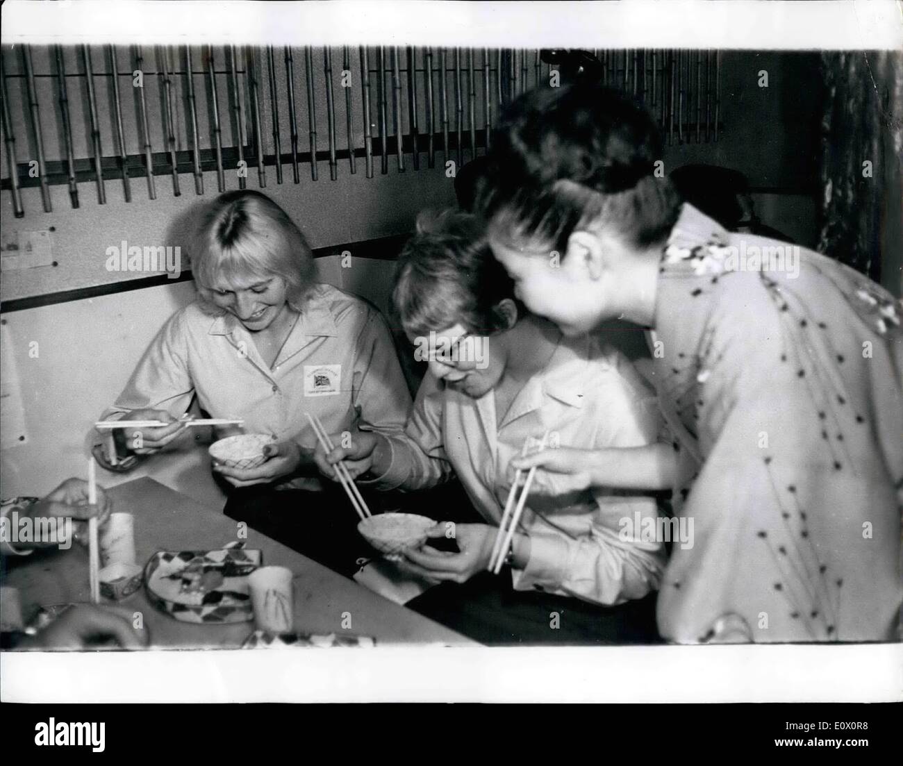 Oct. 10, 1964 - Britain's Girl Olympic Swimmers Try Eating Japanese Style; P[hot Shows Britain's Olympic Girl swimmers Sylvia Lewis (left), 110-meters backstroke, and Jill Slattery 200-metres breaststroke, get into difficulties as they try out chopsticks in a Japanese restaurant in the Tackio. Stock Photo
