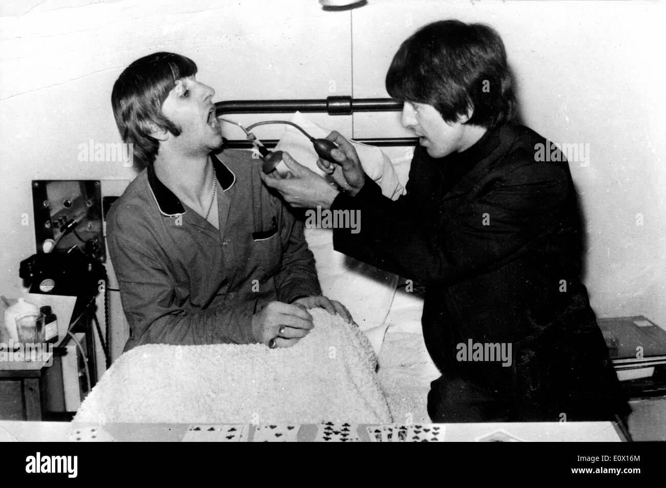 The Beatles George Harrison visiting band mate Ringo Starr in the hospital Stock Photo