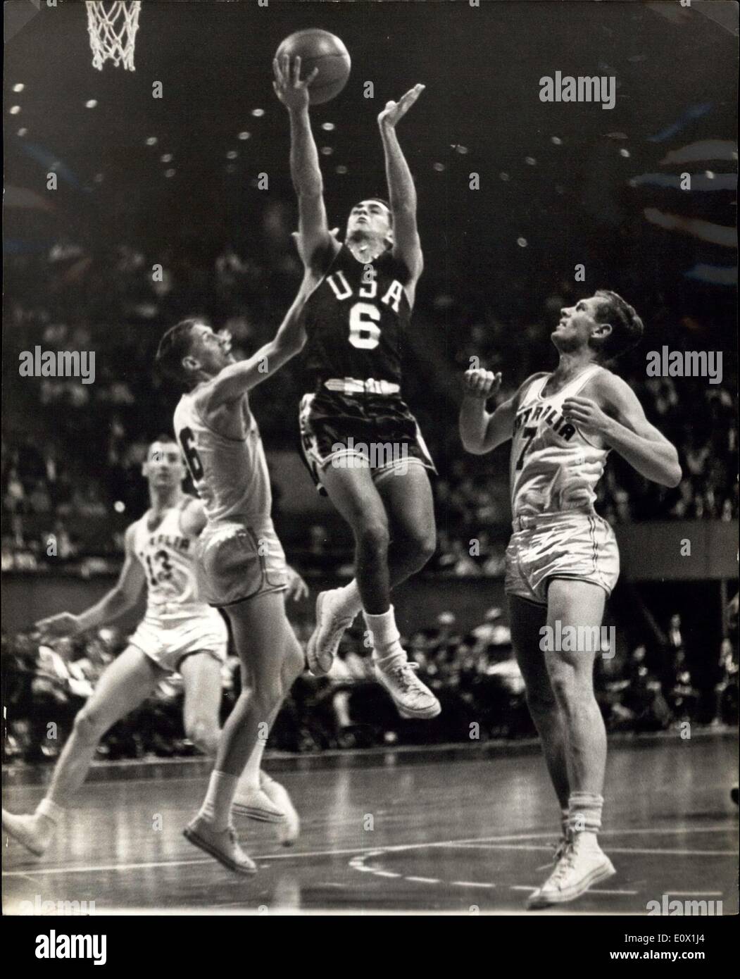 Oct. 14, 1964 - America Scores: Lawrence Brown (N.6) goes up to score for America during the first round group B basket ball match Australian players, left to right are Laszlo Hody (13); John Heard (6), and Williamwyatt. U.S. won by 78 points to 45. Stock Photo