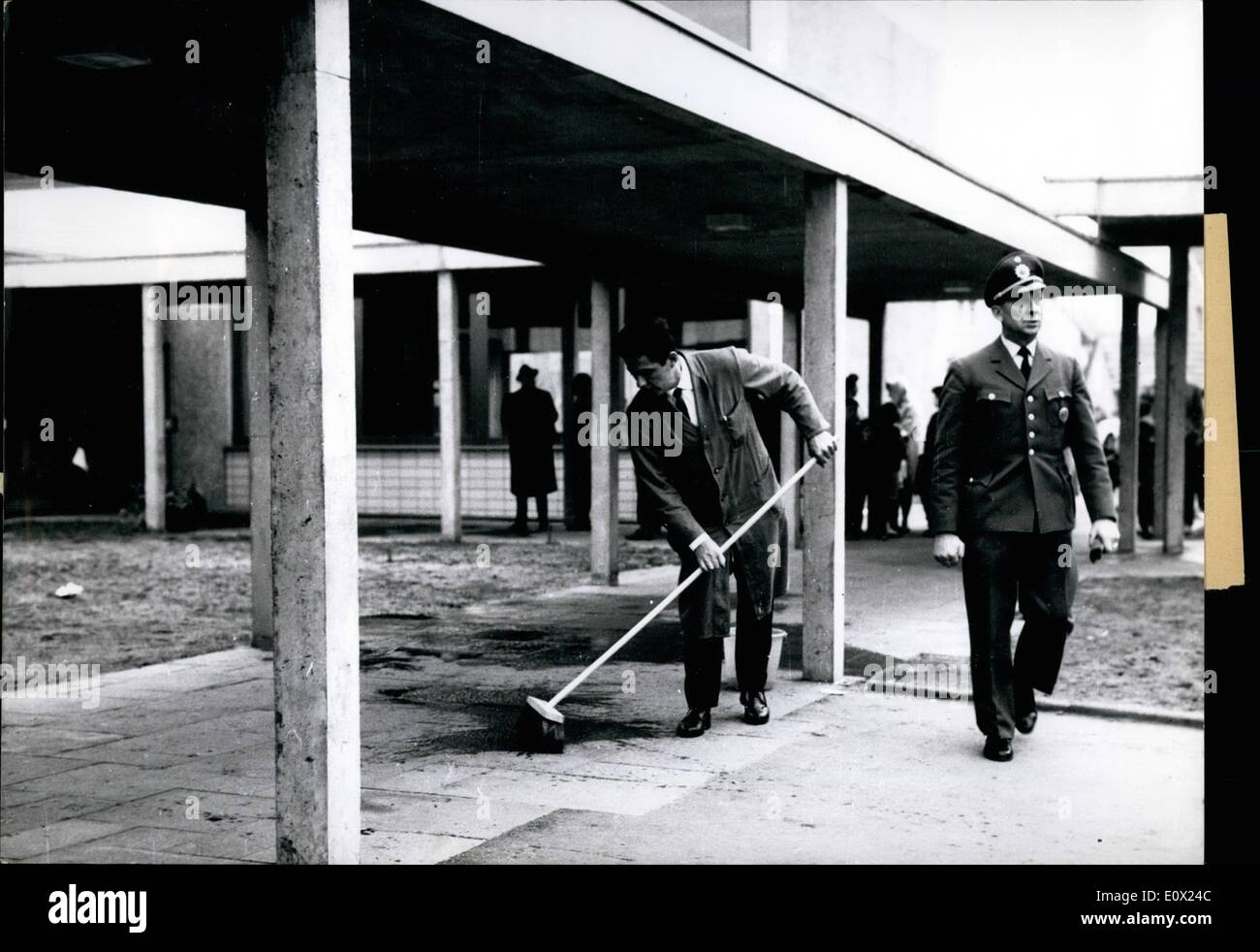 Nov. 11, 1964 - Explosion in school yard, 40 children hurt; 40 school children suffered severe injuries when a blasting slab exploded among the children during a break time. An 11 years old pupil had played with the detonator All children were rushed to hospitals immediately. A police specialist searches for rests of the blast. Stock Photo