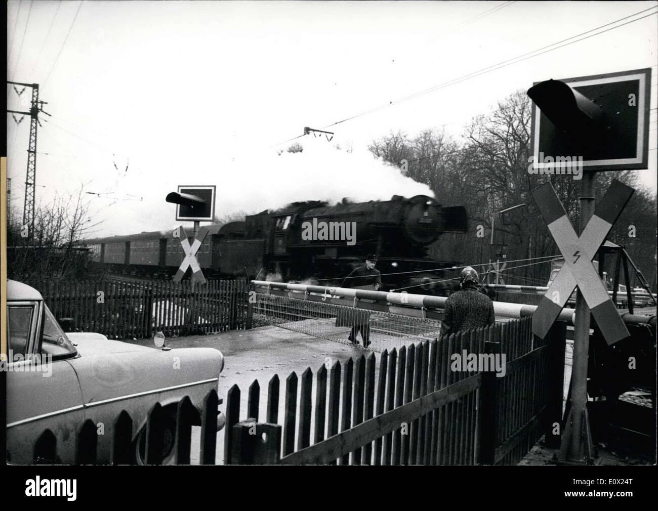 Feb. 04, 1965 - Red Light on Railroad crossing: The Federal Transport Ministry is testing a new signal device on Mail road Crossings near Cologne. On the Closed crossed a red light starts blinking 30 seconds before the gates are closed, this giving motorists safe time to stop their vehicles before the crossing. Stock Photo