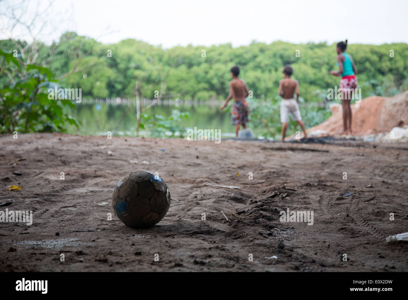 A football and children playing in Mare favela, Rio de Janeiro, Brazil Stock Photo