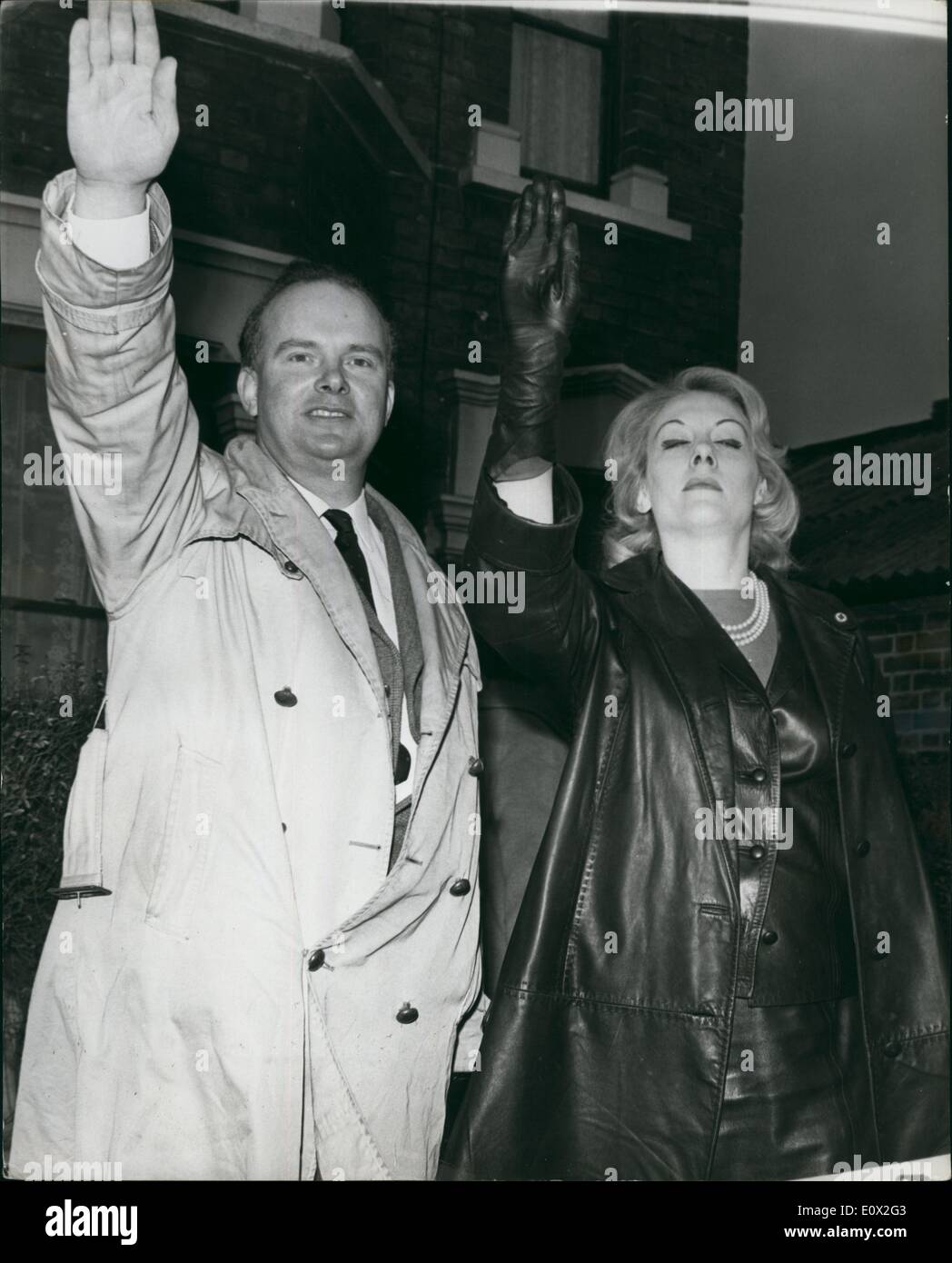 Jan. 01, 1965 - He calls himself ''Mr. Walker Gordon'' Nazi - Colin Jordan and his wife: A man with his face blacked and calling himself Mr. Walker Gordon called at the Leyton Town Hall this afternoon to hand in nomination papers as the Candidate for the National Socialist Movement. Self styled Nazi - Colin Jordan made a speech from the Town Hall steps after the incident. Photo shows Colin Jordan and his wife give the Nazi salute after the incident this afternoon. Stock Photo