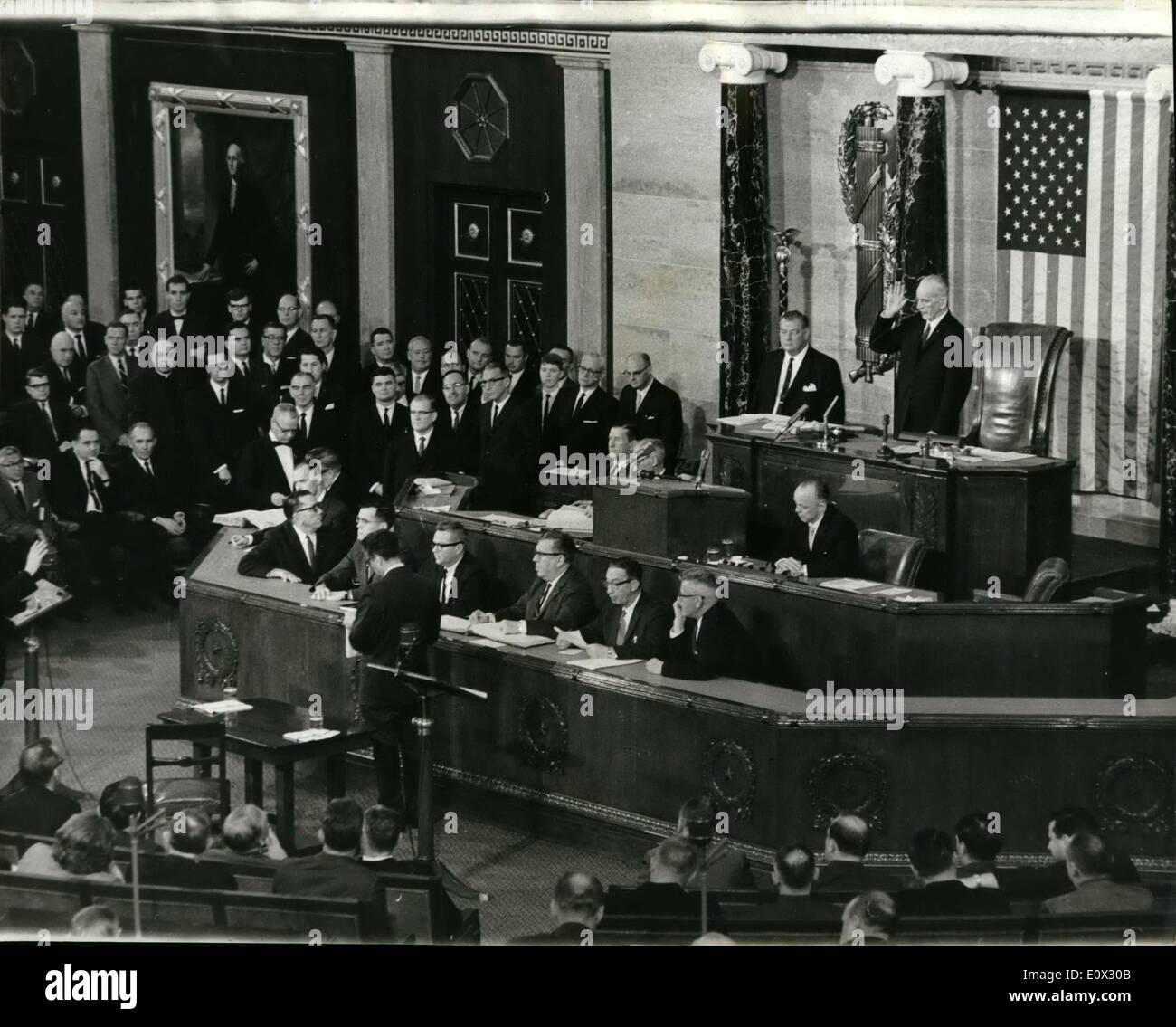 Jan. 01, 1965 - New Speaker of the 89th. Congress Sworn-in.: The 89th. Congress was convened in Washington recently. The new congressman were sworn in a new speaker of the house Mr. John McCormack of Massachusetts was sworn in. Photo shows Mr. John McCormack at the Speaker's Chair is sworn-in by the oldest congressman - Mr. Emmanuel Celler seen in lower left hand corner. (Mr. Celler has seen 40 years service) Stock Photo