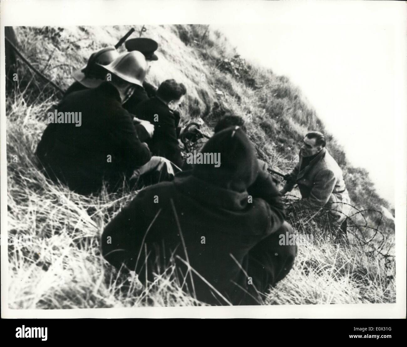 Jan. 01, 1965 - Runaway Borstal boy trapped in Cliff drama after threatening to jump 400-feet : A struggle on a cliff face ended in rescue this afternoon for 20-year-old Londoner, Raymond Herriott, who had escaped from Dover Borstal. Hero of the drama was Mr. Albert Gould, the Governor of the Dover Borstal Institution. He was lowered down the chalk face at Lydden Spout, an isolated spot on the towering cliff between Dover and Folkestone, where the youth was crouching on the ledge with a sheer drop of 400-feet to the rocks below Stock Photo