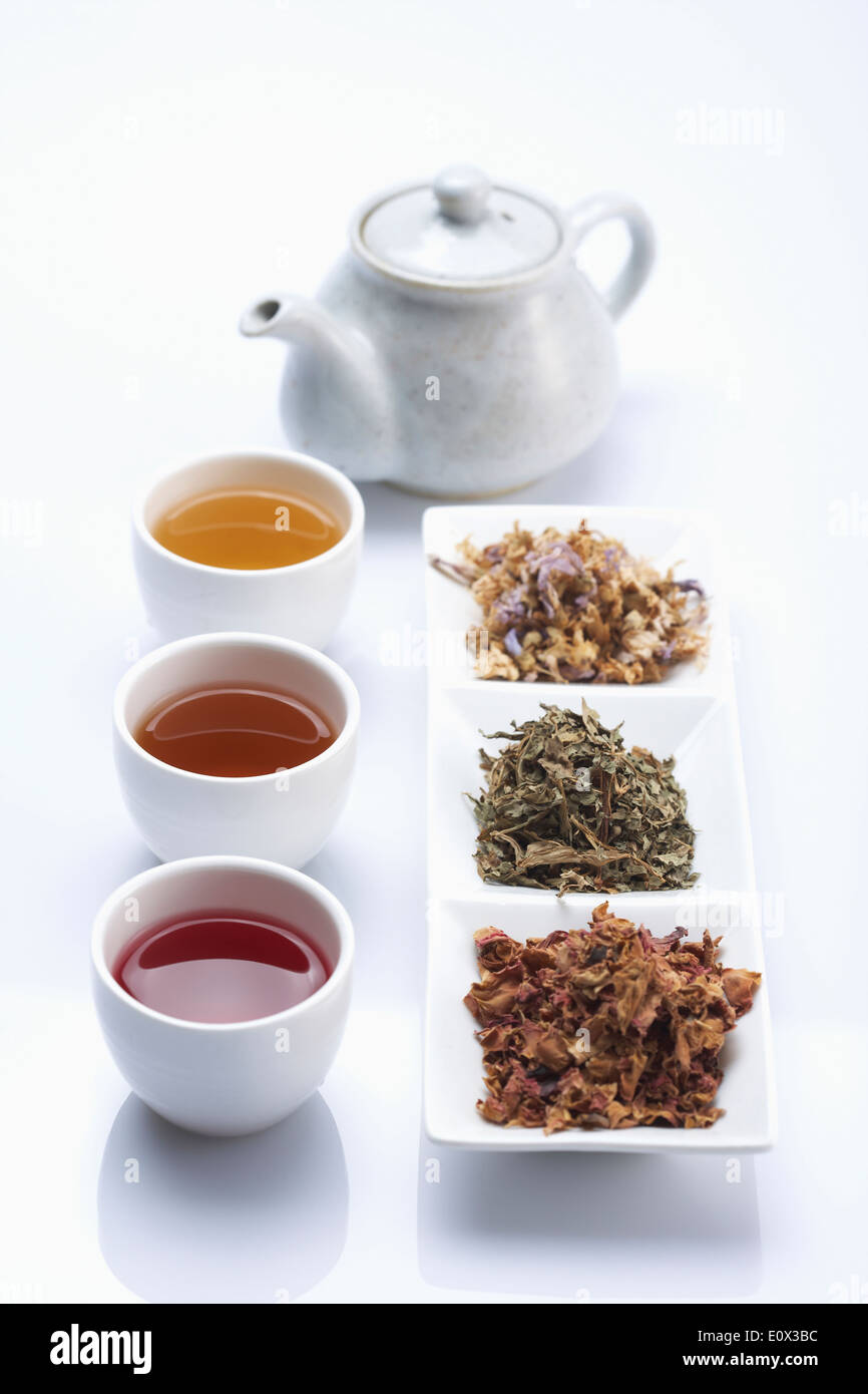 three cups of traditional Korean tea next to Korean finger food Stock Photo