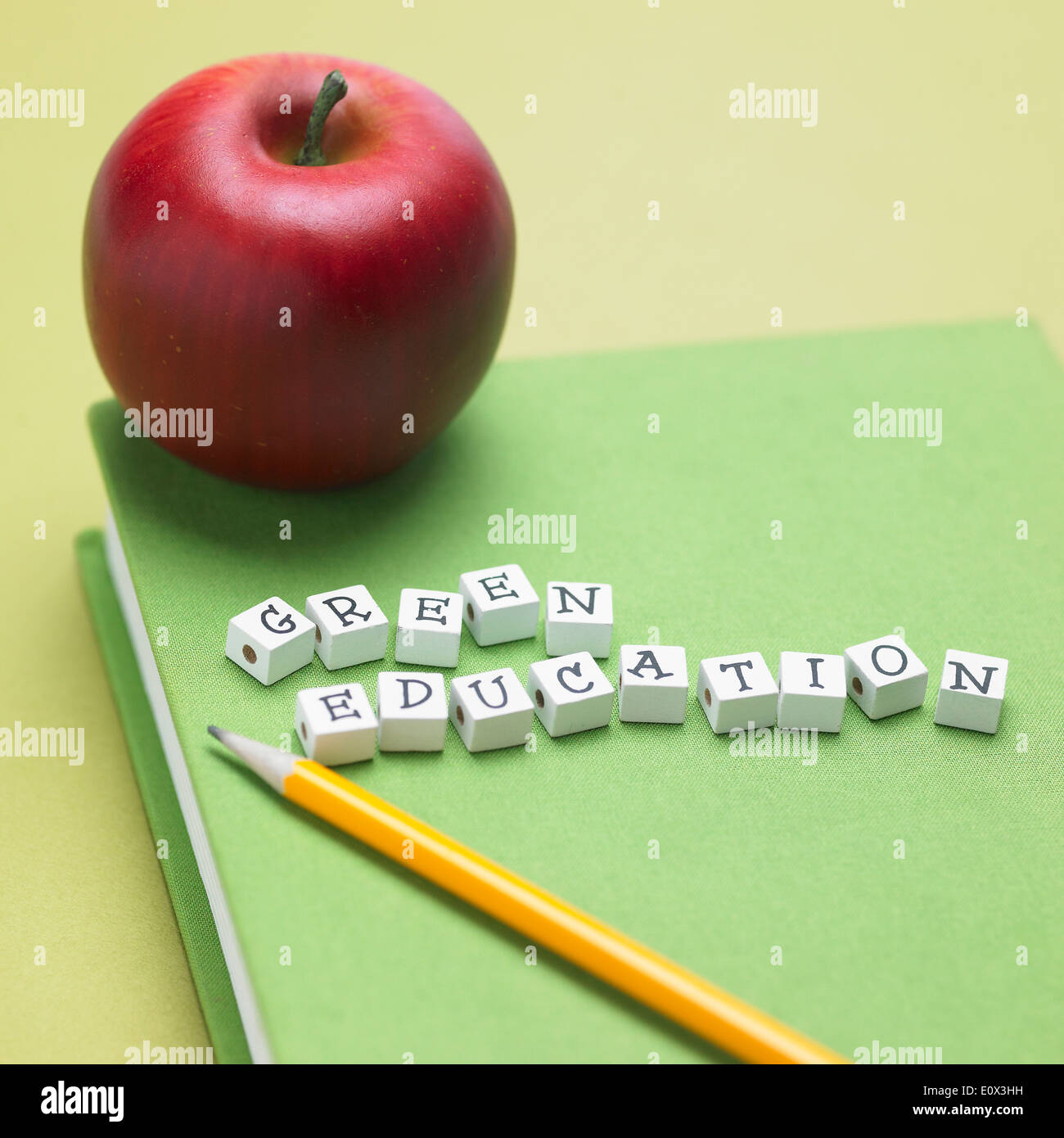 a book with cubes on top spelling green education Stock Photo