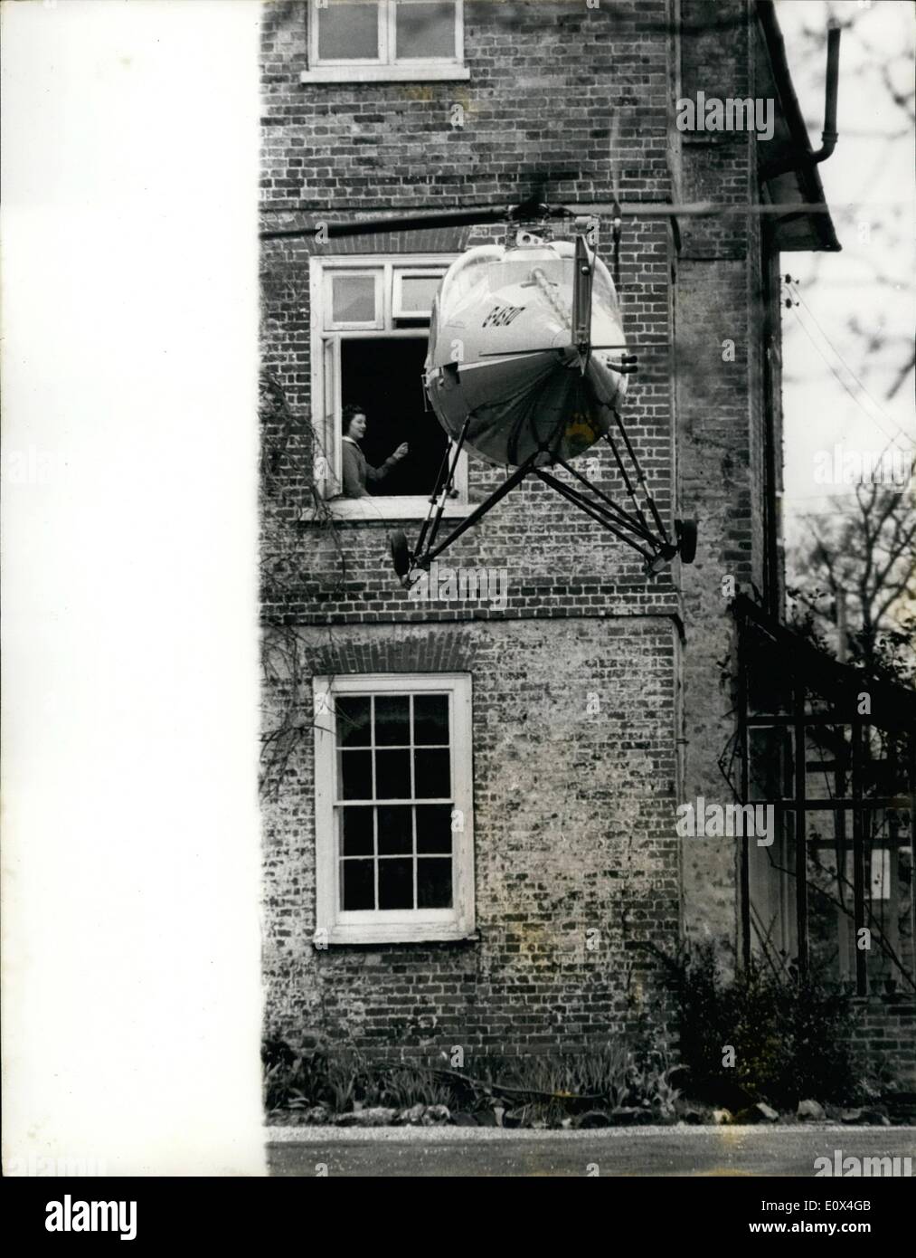 Apr. 04, 1965 - To Work - By Helicopter.: Business man Rowland Absalom was this morning going to work by helicopter instead of his car. It is his solution tothe morning scramble to work. time for the 40 mile journey from his home near Rickmansworth, Herts, to his office in Kent is 23 minutes. In his car it took two to three hours. At his home yesterday where the helicopter has five acres of lawn to land on, his wife Elizabeth, saw him off on his last training trip. At the week-end he was granted a helicopter pilot's licence after 30 hours training in the air, Mr. Absalom gained working hours Stock Photo