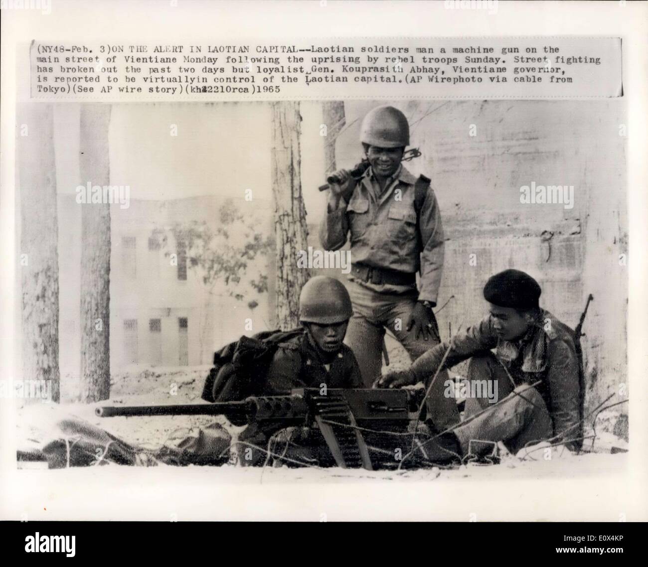 Feb. 03, 1965 - On the Alert in Laotian Capital -- Laotian soldiers man a machine gun on the main street of Vietiane Monday following the uprising by rebel troops Sunday. Street fight has broken out the past two days but loyalist Gen. Kouprasith Abhay, Vietiane governor is reported to be virtyually in control of then Laotian capital. (AP wirephoto via cable from Tokya) (see AP Wire story) (kh2210rea)1965. Stock Photo