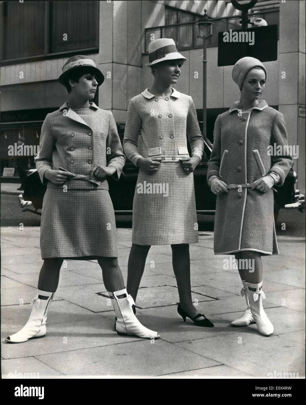 Apr. 04, 1965 - London Fashion Week: The 13th. London Fashion Week - organised by the Fashion House Group of London - opened today at the Hilton Hotel. Photo shows (L to R) : Judith Porteous, wears a Turquoise check and plain pure wool dress and matching double breasted jacket; Sandra Newman wears a double breasted dress with long sleeves in a ''Winter White'' matching check and plain pure wool - and Felicity Downer wears a sand-coloured coat, edged white wool and white leather belt - by Cojana. Judith Porteous' outfit and Sandra Newman' are by Wendy Dress. Stock Photo