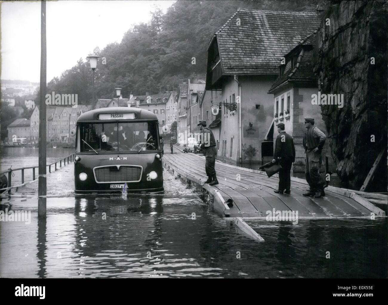 Jun. 06, 1965 - High-water in South Germanu! Since some weeks it is raining ''Cats and Dogs'' in South Germany, specially in Bavaria. Little brooks grow up to great rivers, and the water overflooded streets, fields cellars and meadows. Many streets are blockaded for cars, and the famous ''German Alps-Street'' is also impracticable. Specially the ''Three-River-Town'' Passau is overflowed, the Donau reached a water-high of 9,50m that means 5m more than the normal Stock Photo