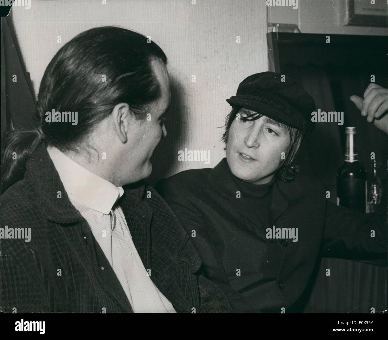 Jun. 06, 1965 - Guess who? Who's the newest Beatle fan? The new P.J. Proby.: Beatle John Lennon has a surprise visit from one of the Beatles most ardent fans. Fellow pop singer P.J. Proby arrived with his new swept back hair-style to wish the boys luck with their one night concert. Stock Photo