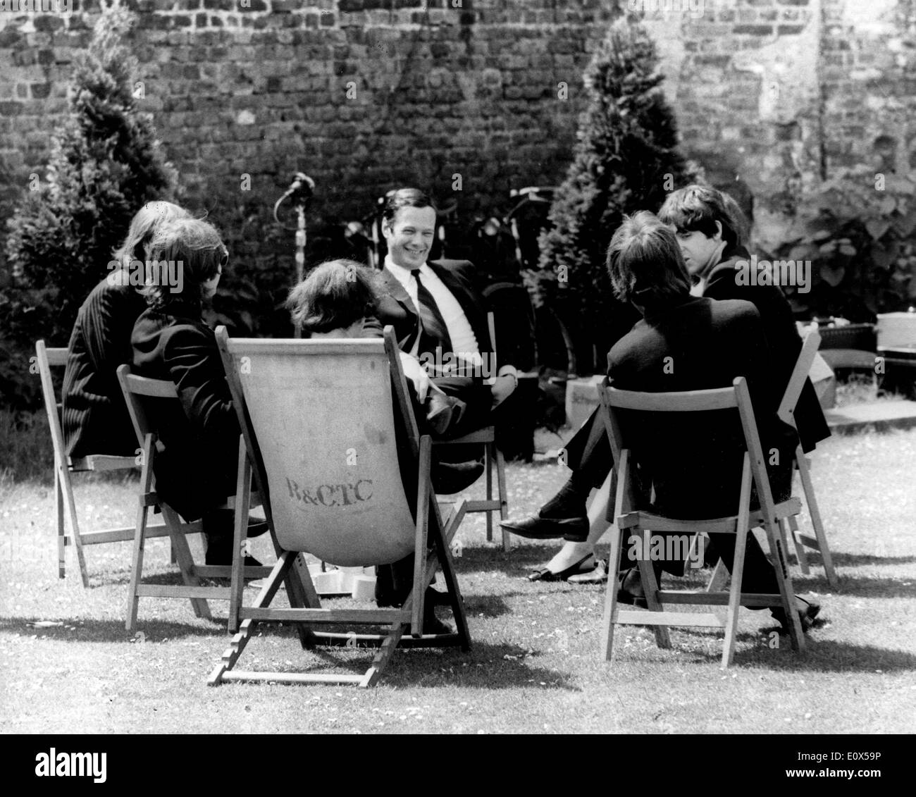 Brian Epstein with The Beatles taking a break from filming a television show Stock Photo