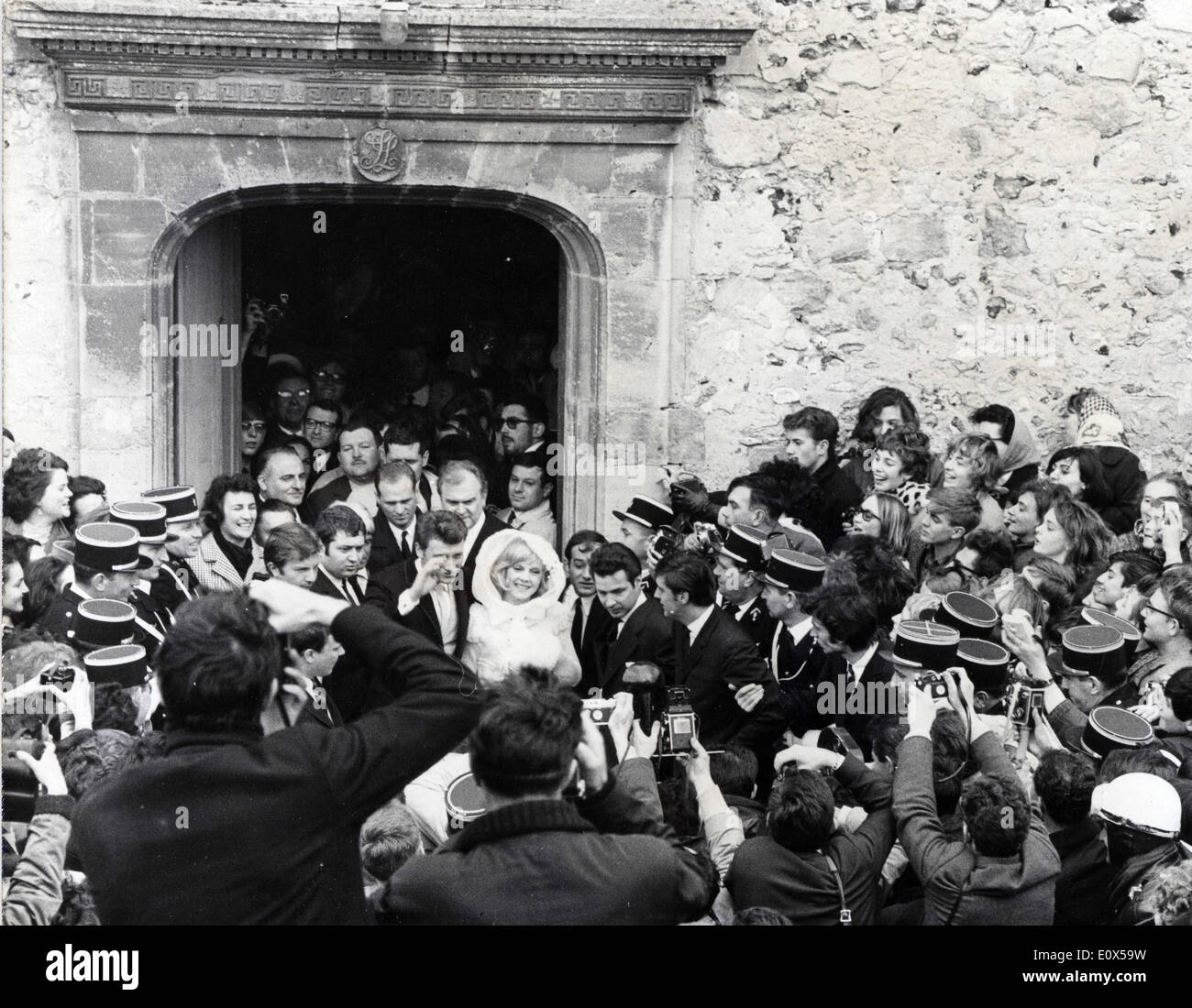 Apr 12, 1965 - Loconville, France - Newlyweds JOHNNY HALLYDAY and SYLVIE VARTAN leave the church they were married in while a massive crowd watches. Stock Photo