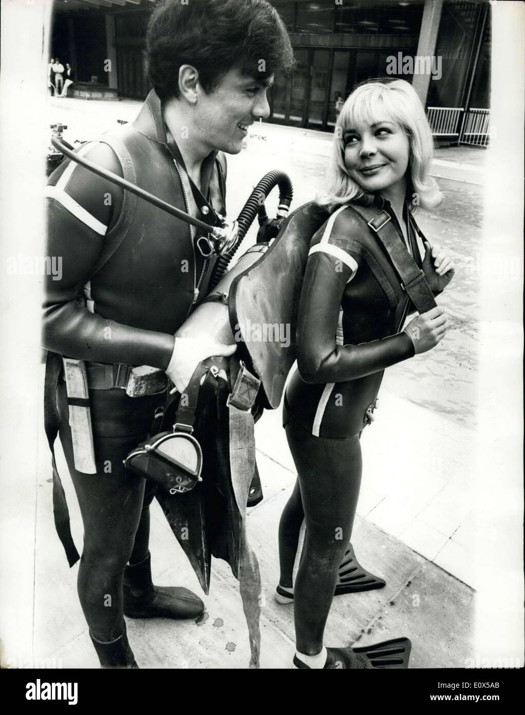 Apr. 15, 1965 - Pop Star Dave Clark Takes The Plunge As A Stunt Man: Dave Clark, the pop star, is just finishing making his first film ''Catch Us If You Can'' Dave wore a frogman's suit yesterday for underwater shots at London's Oasis swimming pool. The singing drummer has been having a rough time during the film making. For Dave plays the part of a stunt man. Photo shows Pop star Dave Clark helps his co-star Barbara Ferris with her air tanks during the filming of the underwater scenes at the Oasis pool yesterday. Stock Photo