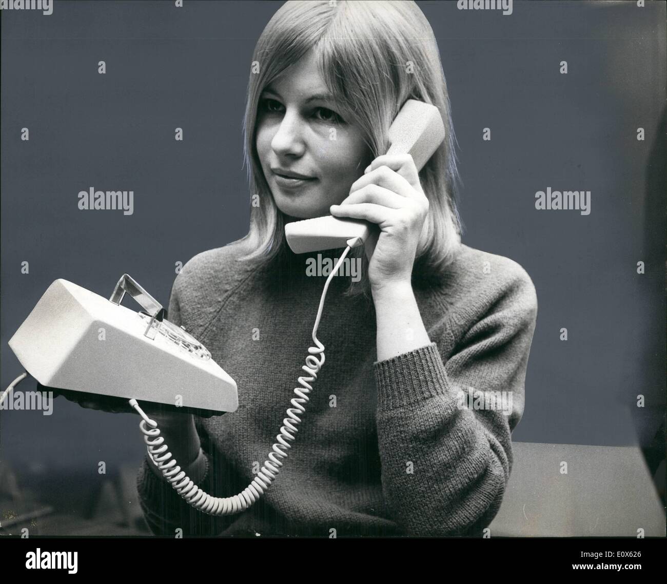 May 05, 1965 - the Telephone That Warbles: This is the new British telephone that ''Warbles'' rather than rings. The tony lightweight phone, being tried out here by secretary Liza Higgs, warbles very softly at first. Then it builds up to a ''peak warble'' which can be set in advance by subscribers. Soon 1000 of the new phone will be installed for testing. Later it will become standard equipment throughout the Britain, gradually replacing the present model Stock Photo