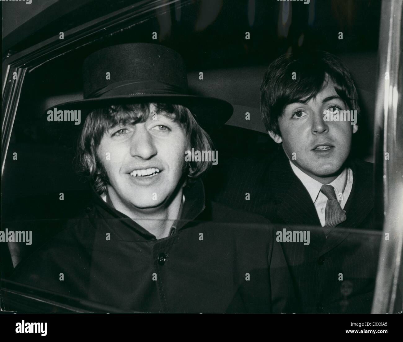 Jul. 07, 1965 - The Beatles return home after their European tour greeted by Hundreds of Fans: This morning the Beatles returned home from Spain after their European Tour end at London Airport Hundreds of fans were their to give them a welcome home. Photo shows Ringo seen in the car with Paul on their arrival back from Spain at London Airport with a Pocador Style hat. Stock Photo