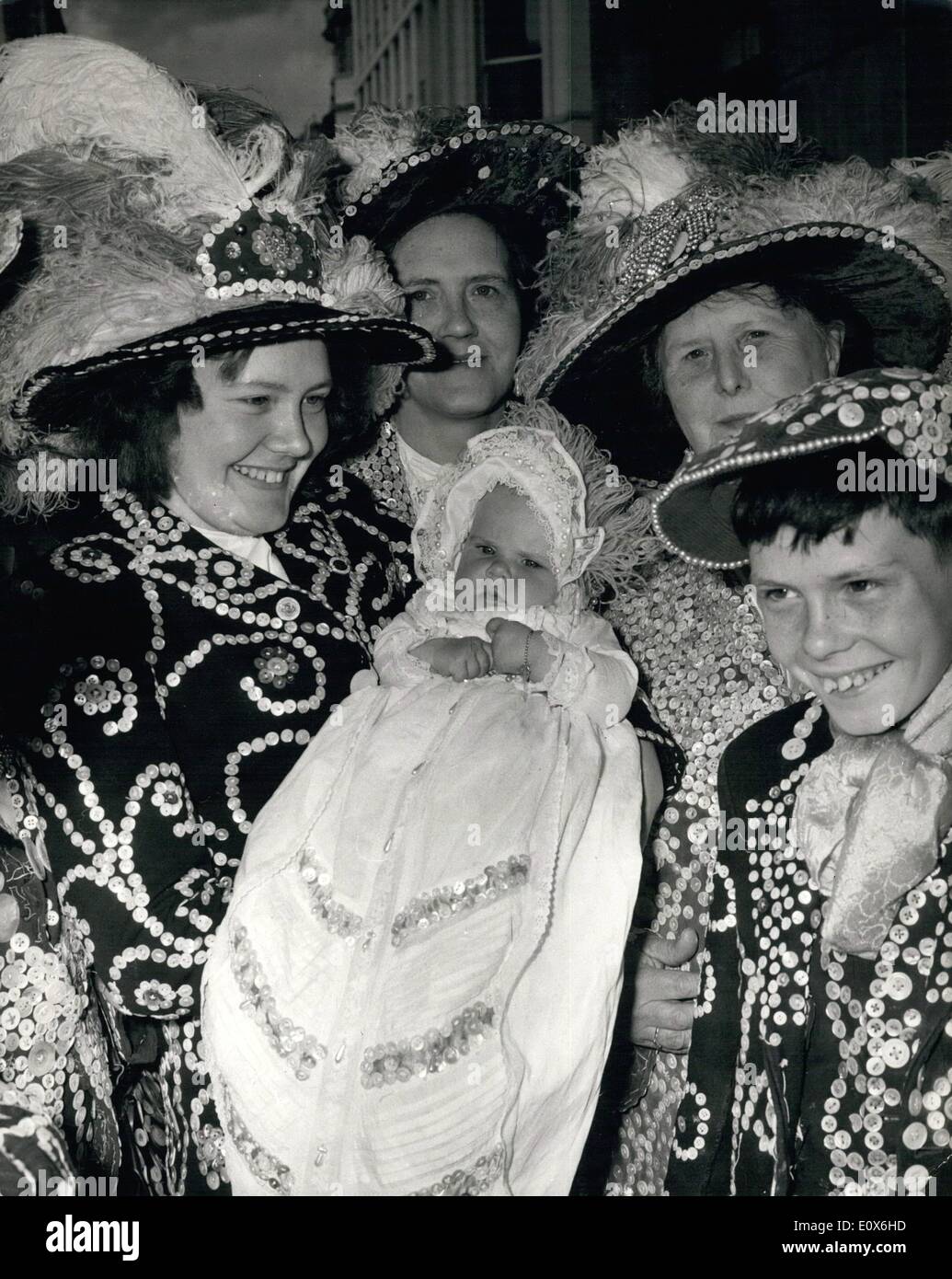 May 05, 1965 - Great-Granddaughter Of London's Festival Of Britain Pearly King IS Christened: Susan O'Shea, the six-month-old Great-grand-daughter of London's Festival of Britain Pearly King, was christened in a robe adorned with 50 buttons at St. Martin-in-the-Fields today. It was made for her great-grandfather towards the end of the last century. All the famous Marriott family now wear the robe for their christenings. Baby Susan was christened by the Rev. Austen Williams, who usually conducts the Pearlies' annual harvest festival service. Photo shows Mrs Stock Photo