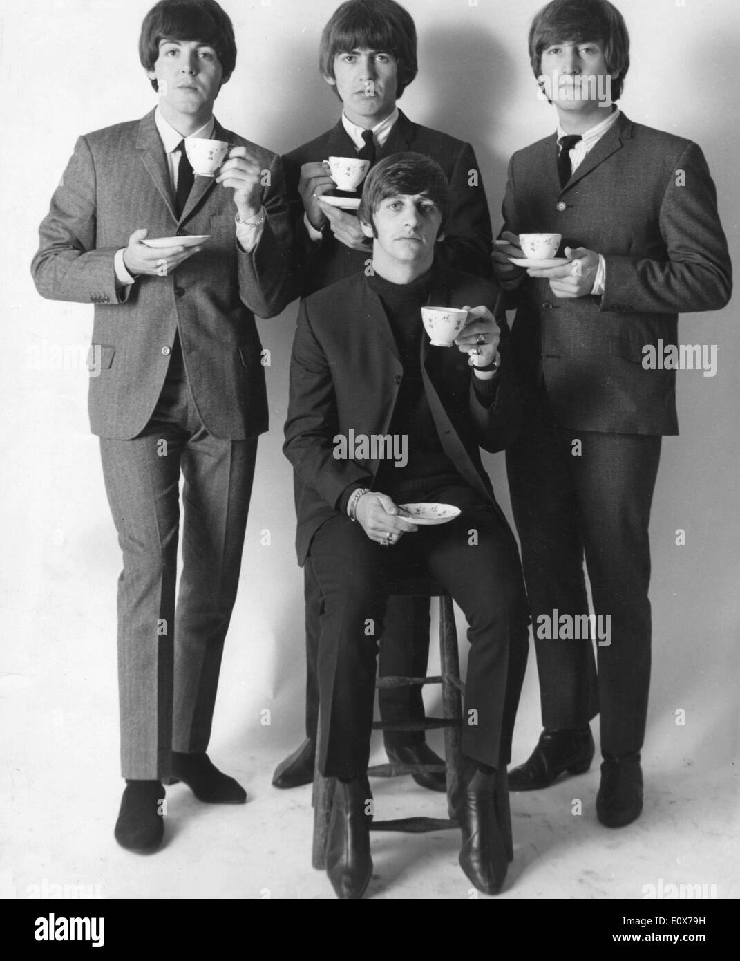 Portrait of the Beatles with teacups and saucers Stock Photo
