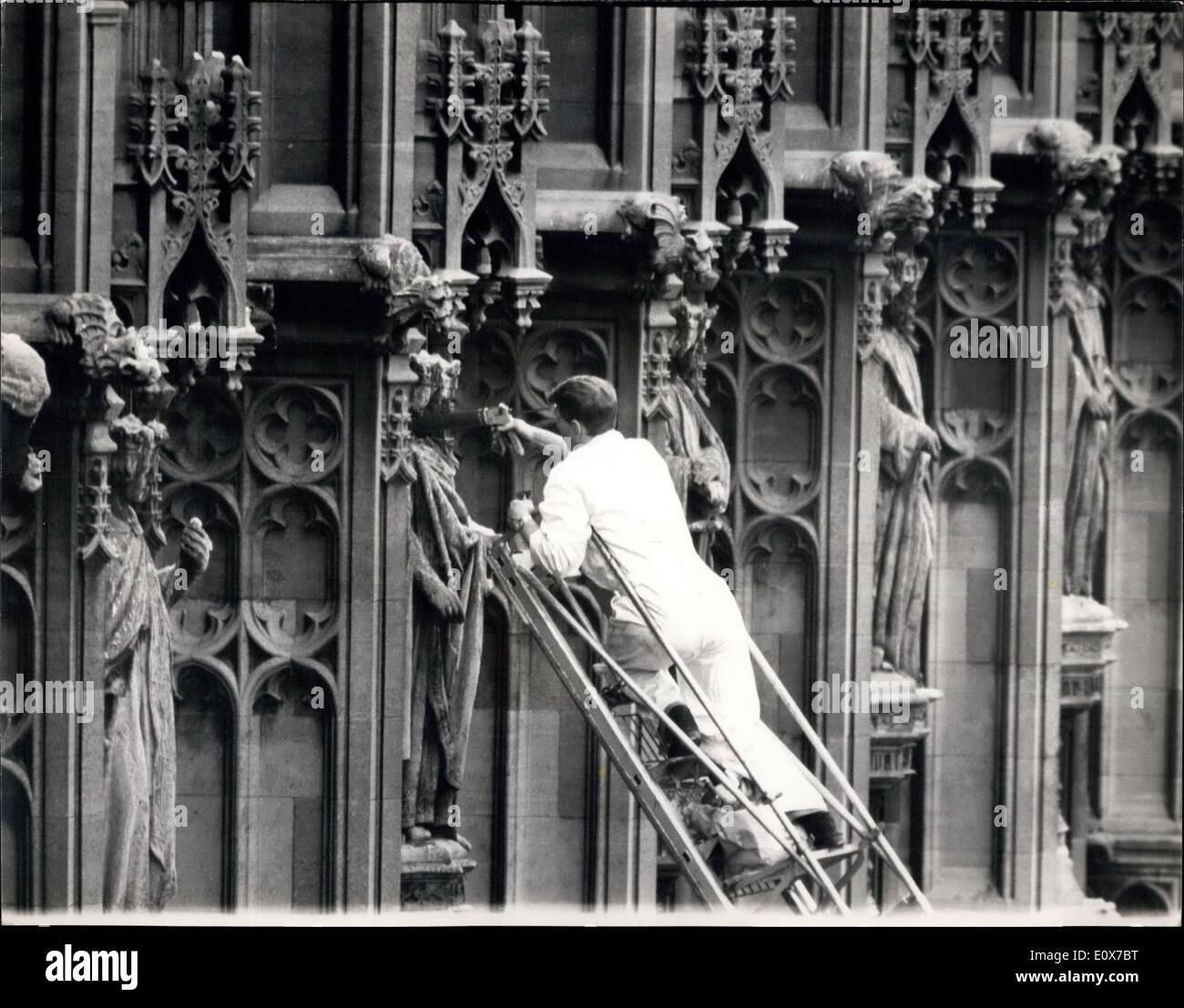 Aug. 26, 1965 - Effort to Rid Parliament of Pigeons.: As part of a plan to rid Parliament and Westminster of pigeons, workmen, armed with guns filled with plastic jelly, squirted jelly round the crowns of the statues of King and Queens, and the coronets of dukes and duchesses, on the colonnades in New Palace Yard , by order of the Ministry of Public Building and Works. The workmen used a 100 -foot fire engine ladder for the task Stock Photo