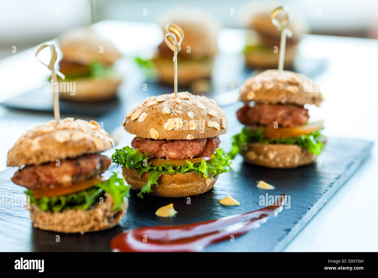 Macro close up of multiple mini hamburgers for catering services. Stock Photo