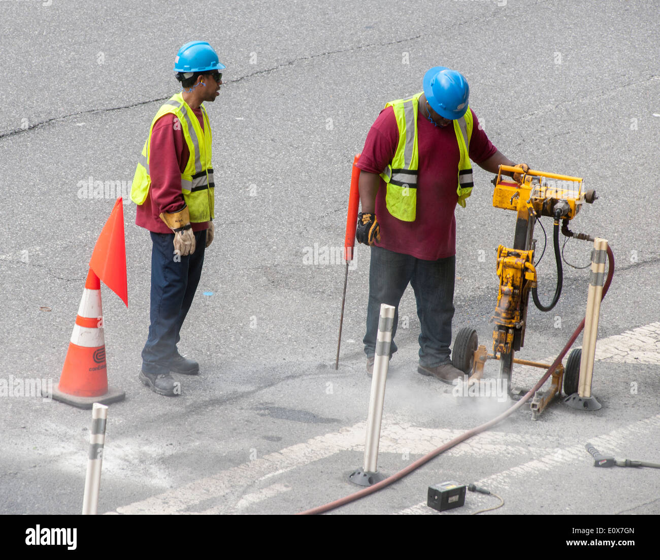 Workers for the Con Edison company use a self-supporting jack hammer in the New York neighborhood of Chelsea Stock Photo