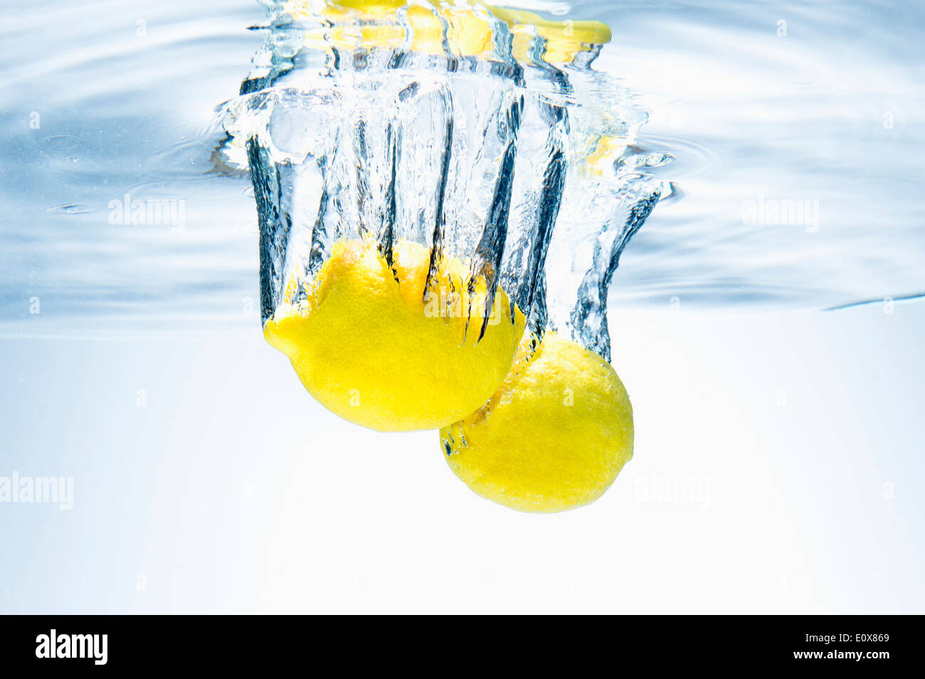 two lemons falling in water Stock Photo Alamy