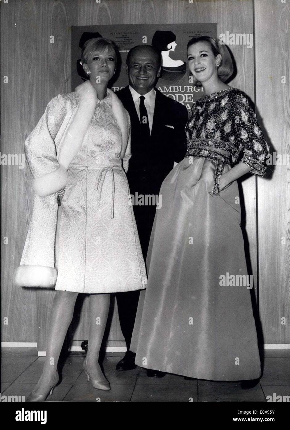 Oct. 09, 1965 - The fashion-show of Pierre Balmain.: Will be the most interesting thing during the 4. Hamburger Modeball (Hamburg Fashion-Dance), which will take place in the Hamburg Atlantic Hotel on November 12th, 65. The famous French fashion-creator will come to Hamburg with 8 of his wonderful mannequins to show his newest creation to the German ladies. On October 8th, Pierre Balmain had a ''test'' in Hamburg, where our photographer could take him. Photo shows Pierre Balmain in the middle of his two mannequins Penny (left) and Danielle (right) Stock Photo