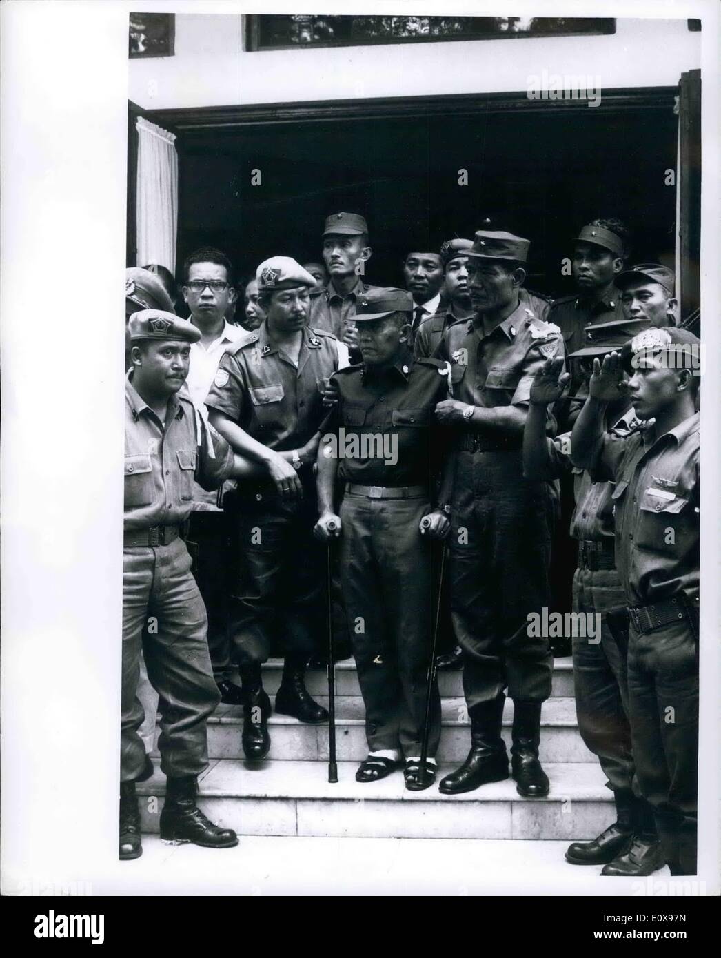 Oct. 10, 1965 - General Abdul Haris Nasution, Indonesian Defense Minister, on steps of his home in Djakarta, Oct. 7, 1965 during funeral for his 5-year old daughter who was fatally wounded during the abortive Communist coup of Oct. 1, 1965, Grief stricken, he is being helped by an aide. Nasution escaped by jumping over the back fence and hiding in Iraqi embassy. In doing so, he injured his ankles. Stock Photo