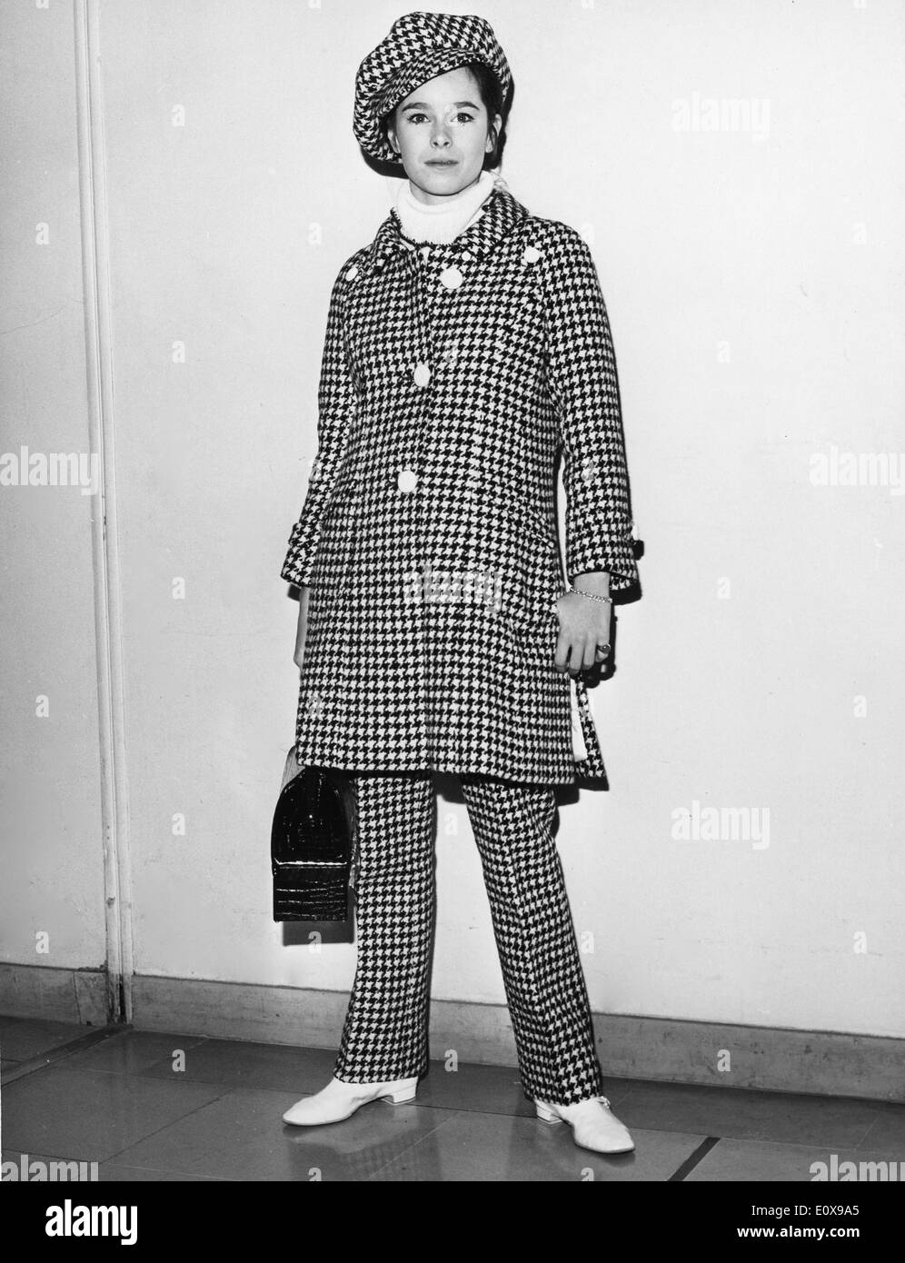 Dec. 7, 1965 - Paris, France - Ballet dancer GERALDINE CHAPLIN wearing a checkered outfit prepares to board a plane at Orly Airport to New York, for the premiere of the film, 'Doctor Zhivago.' Stock Photo