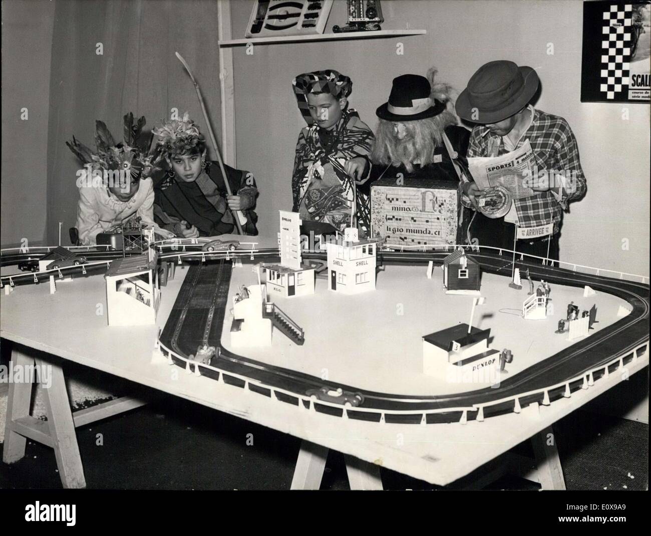 Dec. 09, 1965 - Toys and games exhibition opens at decorative arts museum: An exhibition of toys and games organised under the sponsorship of the youth and sports ministry opened at the Museum of decorative arts in Paris today. Photo shows the first visitors in fancy dresses admiring a miniature racing car track. Stock Photo