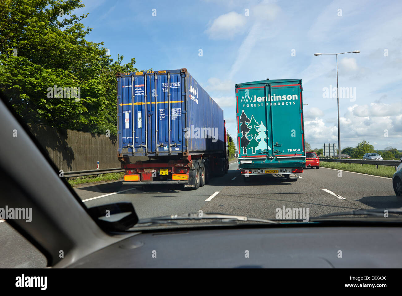 driving behind overtaking lorries on the M6 Motorway England UK Stock Photo