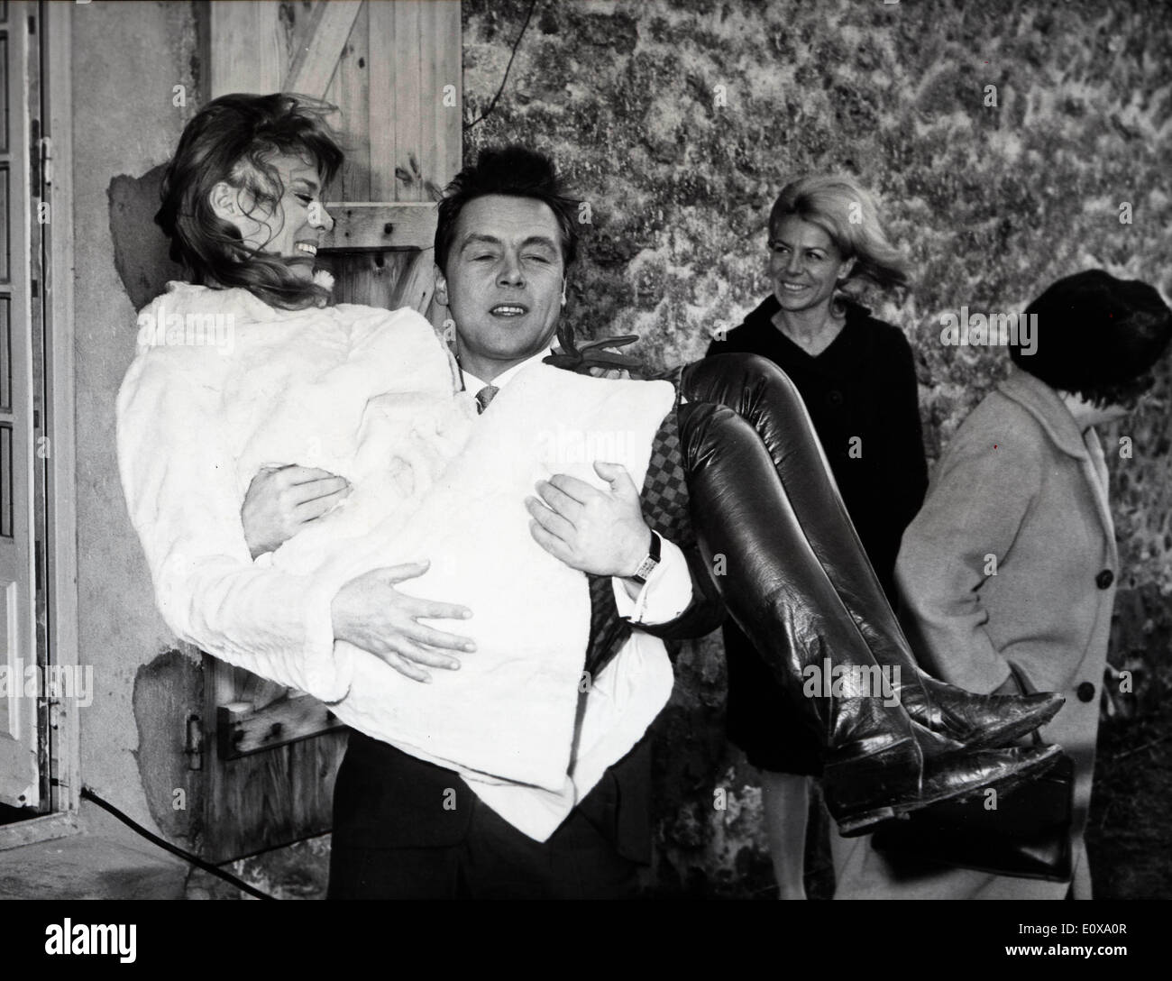 French actress DORA DOLL is lifted by her new husband, French singer FRANCOIS DEGUELT on their wedding day. Stock Photo