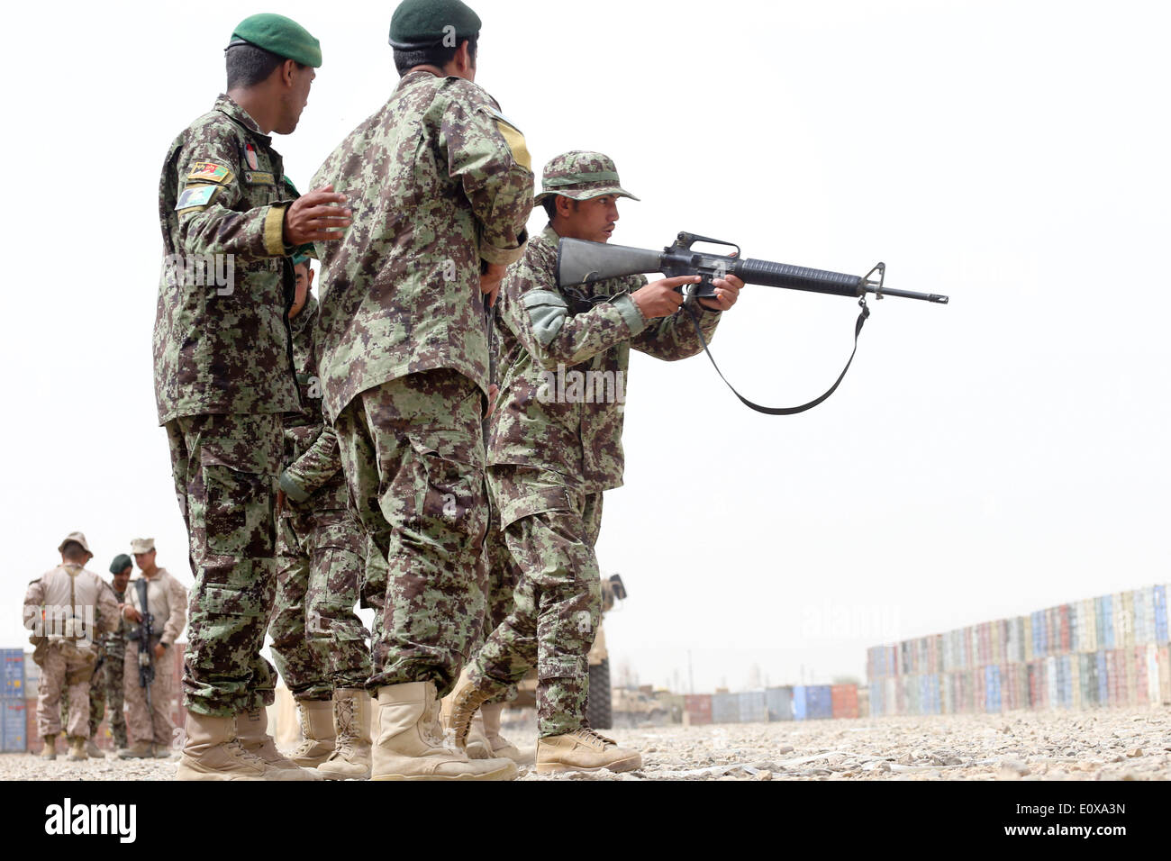 An Afghan instructor provides instruction to soldier with the 4th TOLAY, 215th Corps, Afghanistan National Army during a tactical procedure exercise May 17, 2014 at Camp Shorabak, Helmand province, Afghanistan. Stock Photo
