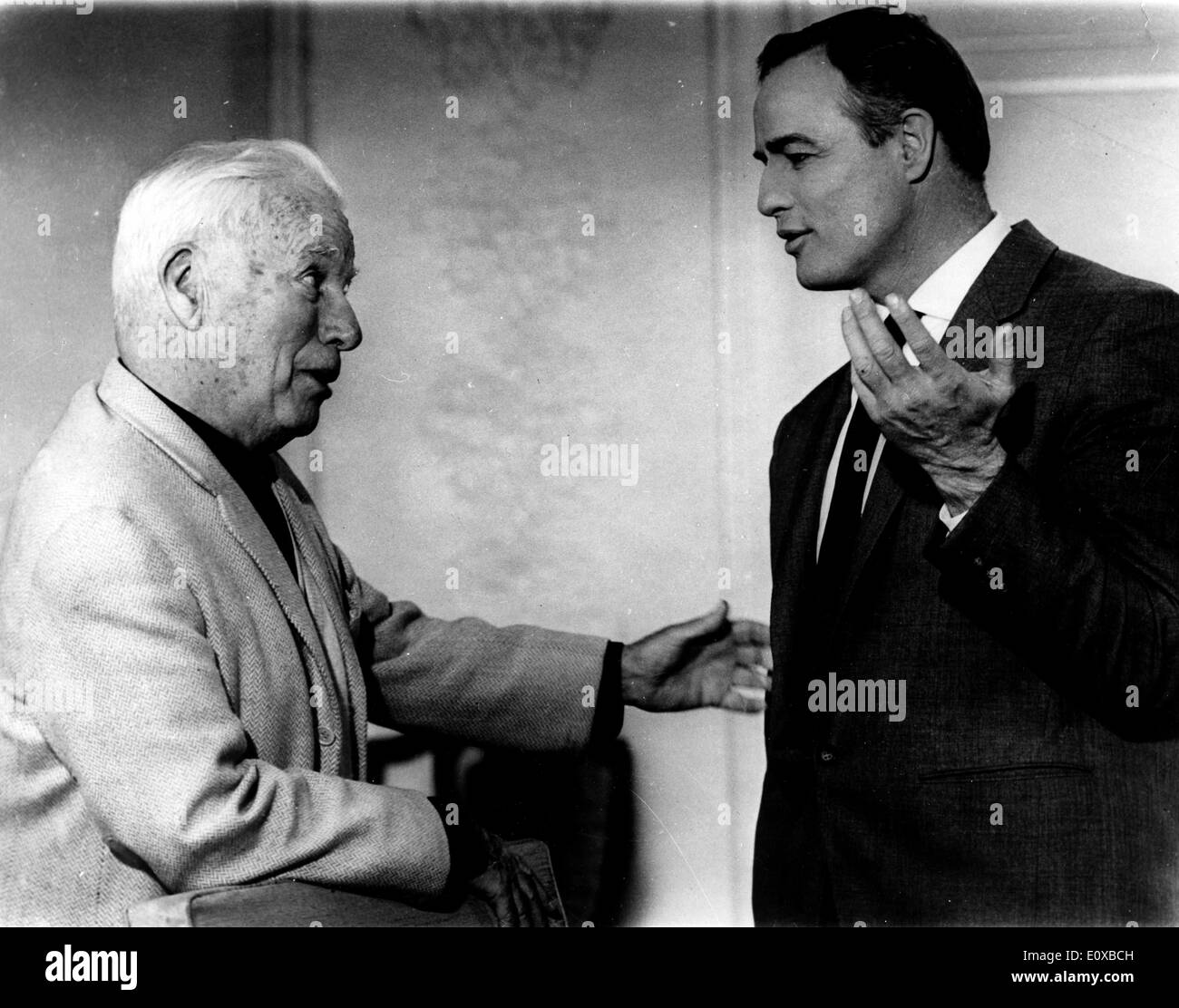 Actor Marlon Brando talking to director Charlie Chaplin Stock Photo