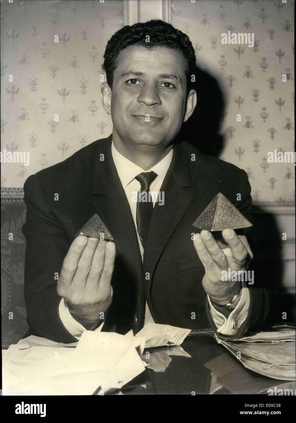 Mar. 18, 1966 - Israeli peace pilot in paris: Israeli ''peace pilots abie Nathan who flew to Egypt with ''peace offers'' for Nasser, is now in paris. Said Abie: ''I hope general De Gaulle will agree to grant me an interview''. Photo shows ''place pilot'' pictured in lhis paris Hotel. The two miniatures pyramids he is showing are a gift he received in port Said. Stock Photo