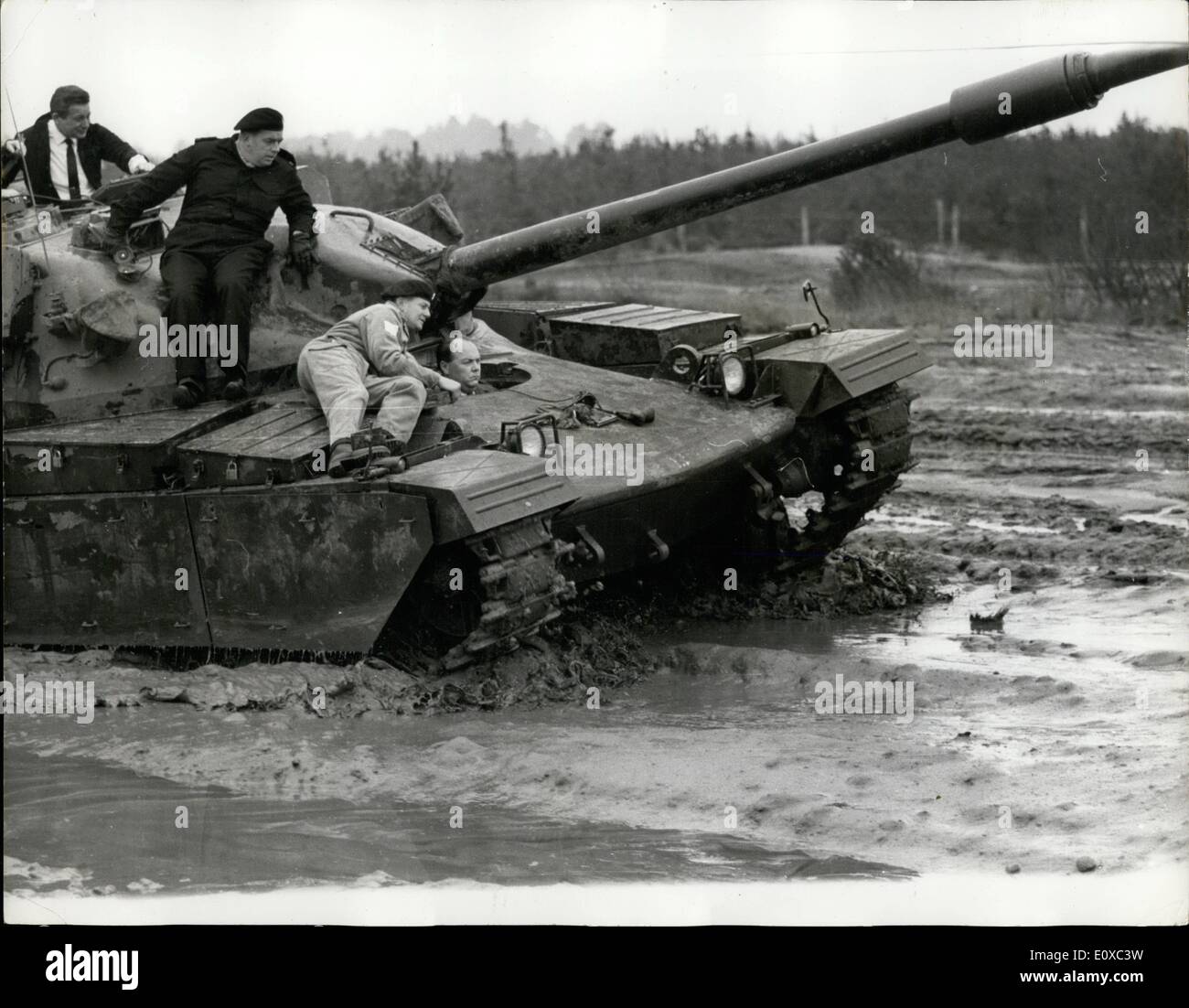 Feb. 02, 1966 - The Army Minister Gets a Mudbath as he tries out Army Minister Mr. Gerry Reynolds, tested Britain's newest and biggest tank, the 50-ton Chieftain, yesterday - and gave himself a mudbath. It happened when the Minister decided to drive the giant tank himself over a water logged stretch of open country at the Army's testing ground at Bovington Camp in Dorset. It was Mr. Reynold's first attempt at driving a tank. He drove off with his instructor, Sergeant Bert Gurr sitting beside him in the forward driving position. The tank ploughed through a huge puddle, and Mr Stock Photo