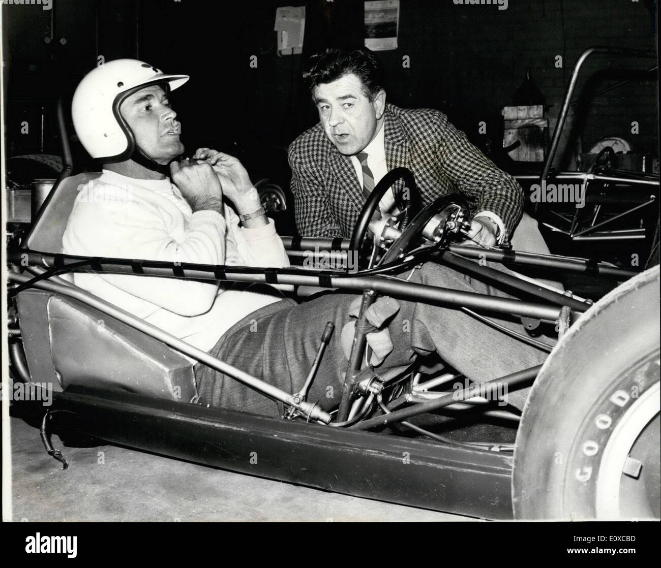 Apr. 04, 1966 - Motor Racing Tips for Maverick James Garner, star of television series Maverick, who has been in Britain for film talks, pictured behind the wheel yesterday as he receives some tips on motor racing from Jim Russell, at his racing drivers school at Snetterton, Norfolk yesterday. Garner was due to fly home to New York today. Stock Photo