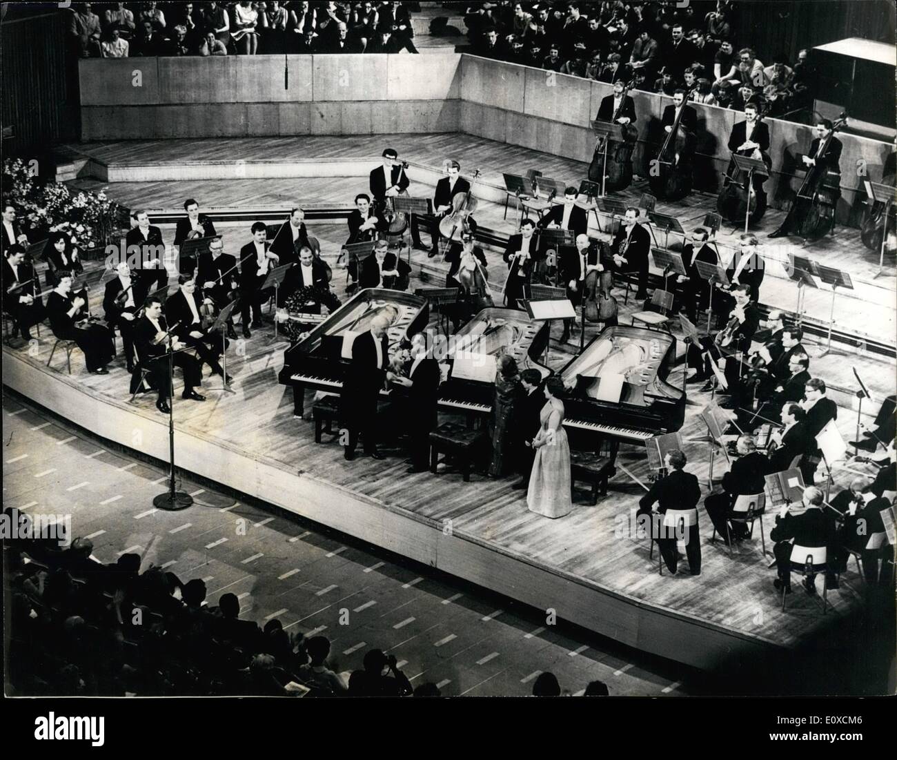 Apr. 04, 1966 - Yehudi Menuhin's Fiftieth Birthday Concert: The famous violinist Yehudi Menuhin's Fiftieth Birthday Concert, took place last night at the Royal Festival Hall, in aid of his music school at Stake D'Abernon. During the concert, Yehudi Menuhin conducted his two sisters, Yaltah and Hephzibah Menuhin and his 14-year old son Jeremy in the Mezart three-piano concerts. The concert also marked Jeremy's London debut as a concert pianist. Photo shows Sir Adrian Boult hands Yehudi Menuhin a cheque for the Yehudi Menuhin Music School, at the Royal Festival Hall last night. Stock Photo