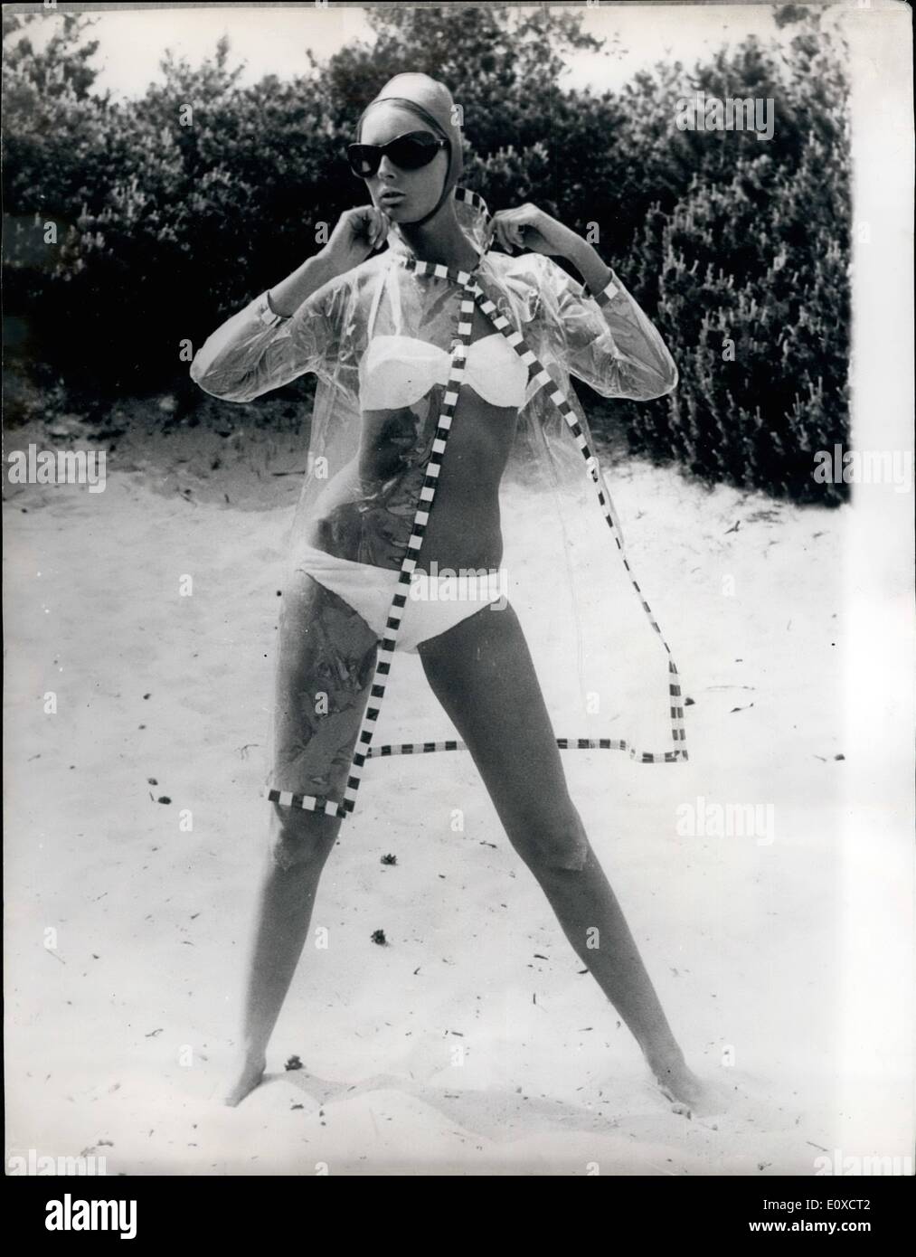 Jun. 06, 1966 - BELIVE IT OR NOT A RAINCOAT TO KEEP MY LADY'S BIKINI DRY. PHOTO SHOWS:- The latest thing from Denmark is this transparent raincat made of plastic which can be worn over the young ladies bikini down on the beach. Stock Photo