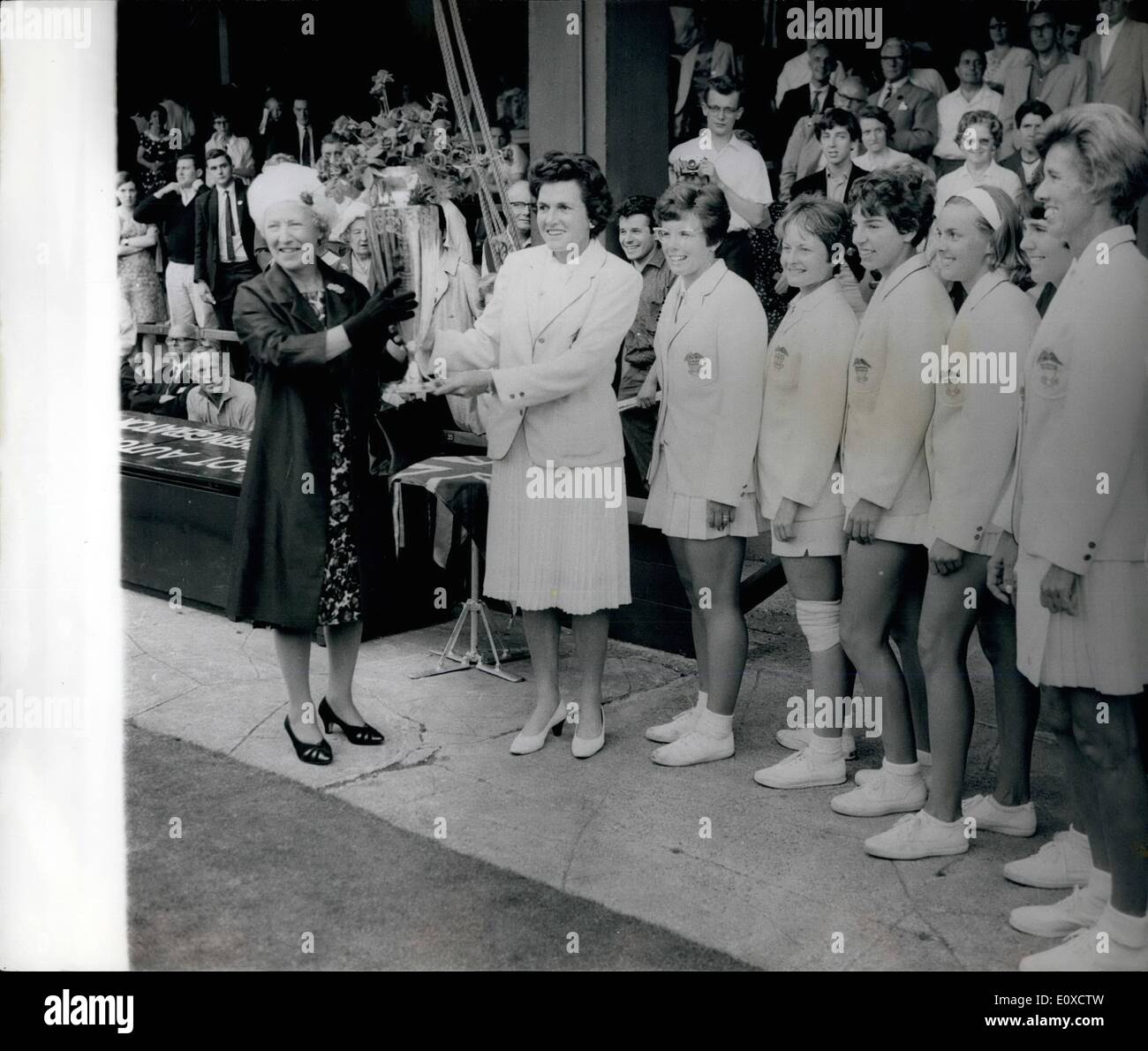 Jun. 06, 1966 - Wightman Cup At Wimbledon America Win 4-3: Photo Shows Lt. R. Mrs. Harrison wife of the Chairman of L.T.A. presents the Wightman Trophy to Miss Margaret Varner, to non playing Cpt of the winning U.S. team looking on.after beating G.B. by 4-3 at Wimbledon today. Stock Photo