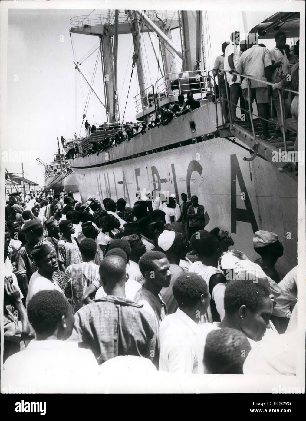 Jun. 06, 1966 - Tribal Conflicts Uproot Nigerians: Picture 2, shows on-board Yorubas (Western Nigerians) in the ship which brought them to Lagos from the East. Worried and expectant relations who had gathered to see if their relations were among those the ship brought down from the East, are seen by the ship. Some of them left the dockyard disappointed their relations were either on their way home or had been slaughtered. Stock Photo