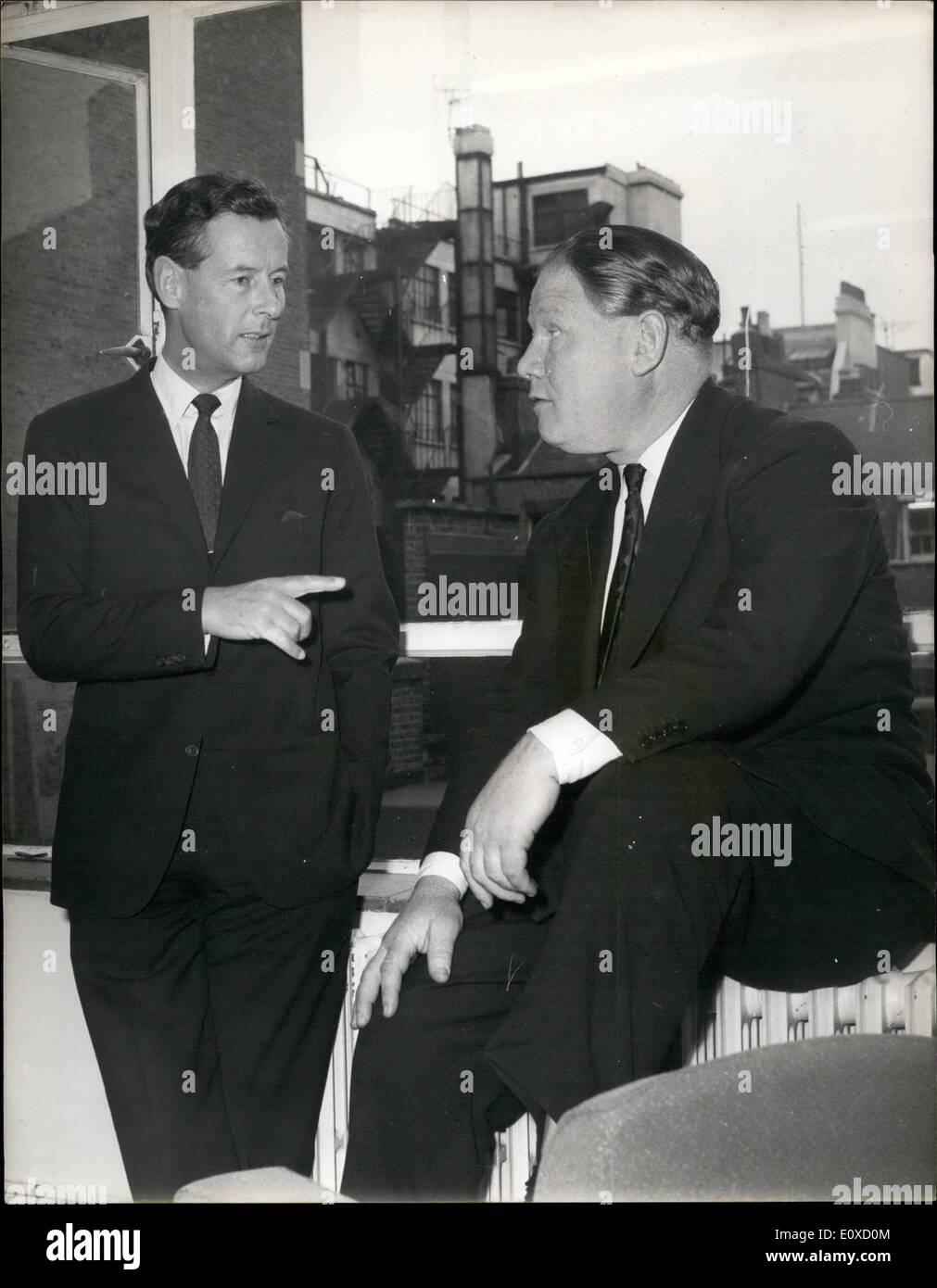 Apr. 04, 1966 - Group Captain Townsend Starts Work In London: Group Captain Peter Townsend, 51, the former Royal equerry, who has lived abroad for the past 13 years, this morning started work for the London public relations firm of Hodgkinson Partners. Photo shows Group Captain Peter Townsend, talks to Mr. Colin Hodgkinson, the chairman of Hodgkinson-Partners - on his first morning. Stock Photo